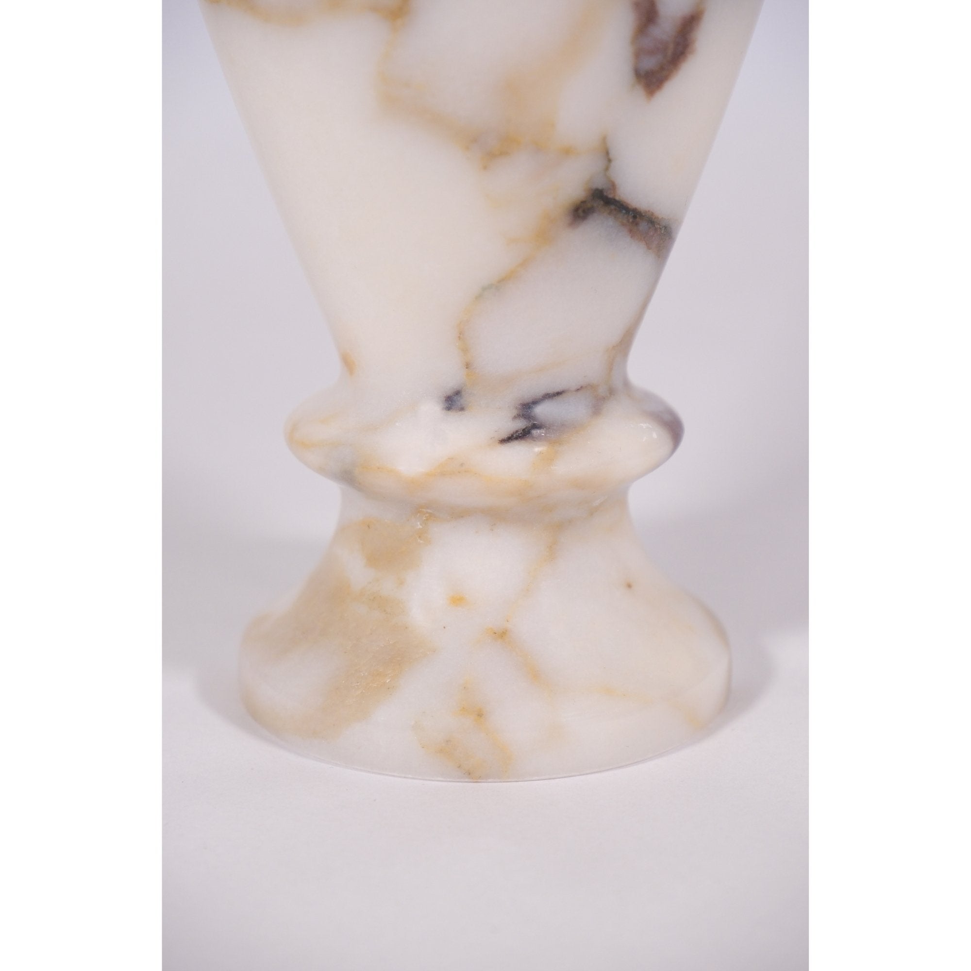 Close-up of Calacatta Viola marble vase base – detailed natural stone texture