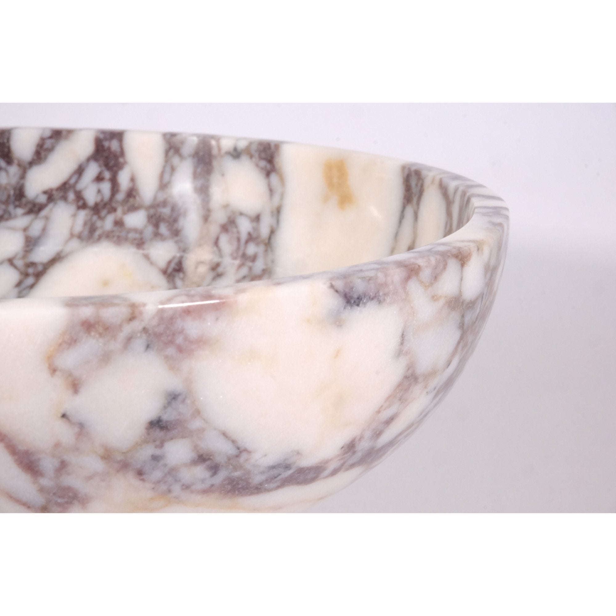 close up of rim and texture on calacatta viola marble pedestal bowl highlighting creamy white and deep violet veins