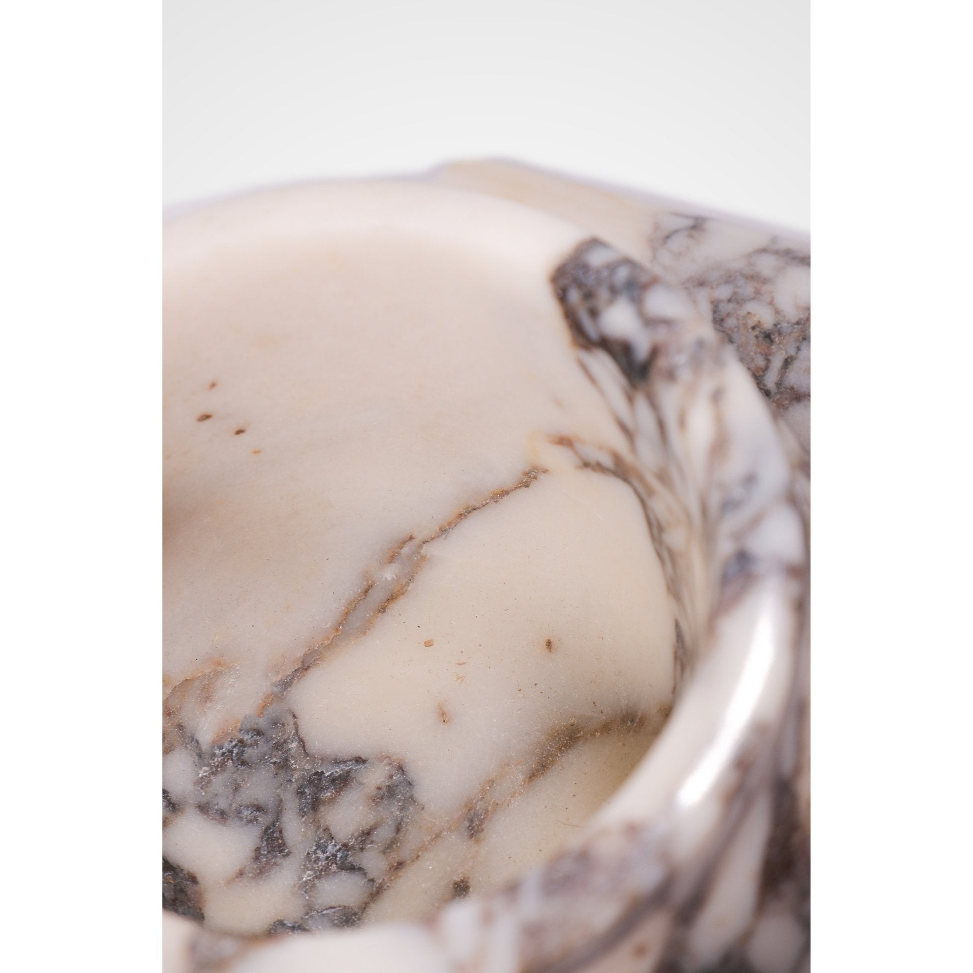 Close-up of natural marble veining and polished texture, showcasing the artisan craftsmanship of Petra Vera.