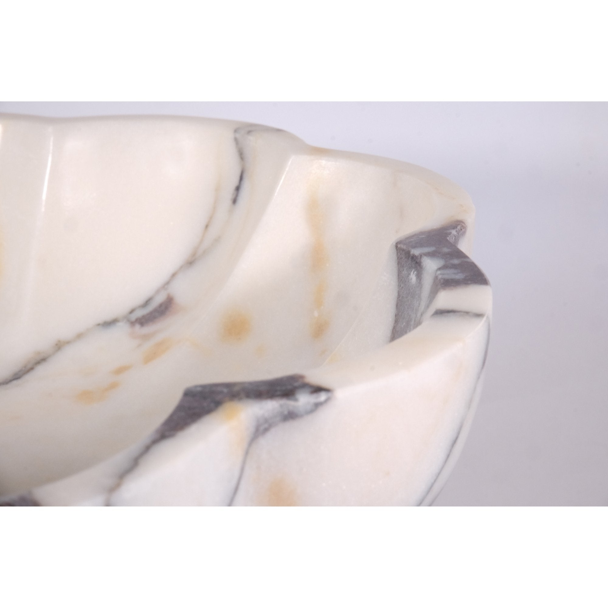 Close-up detail of honed marble rim and Calacatta Viola veins