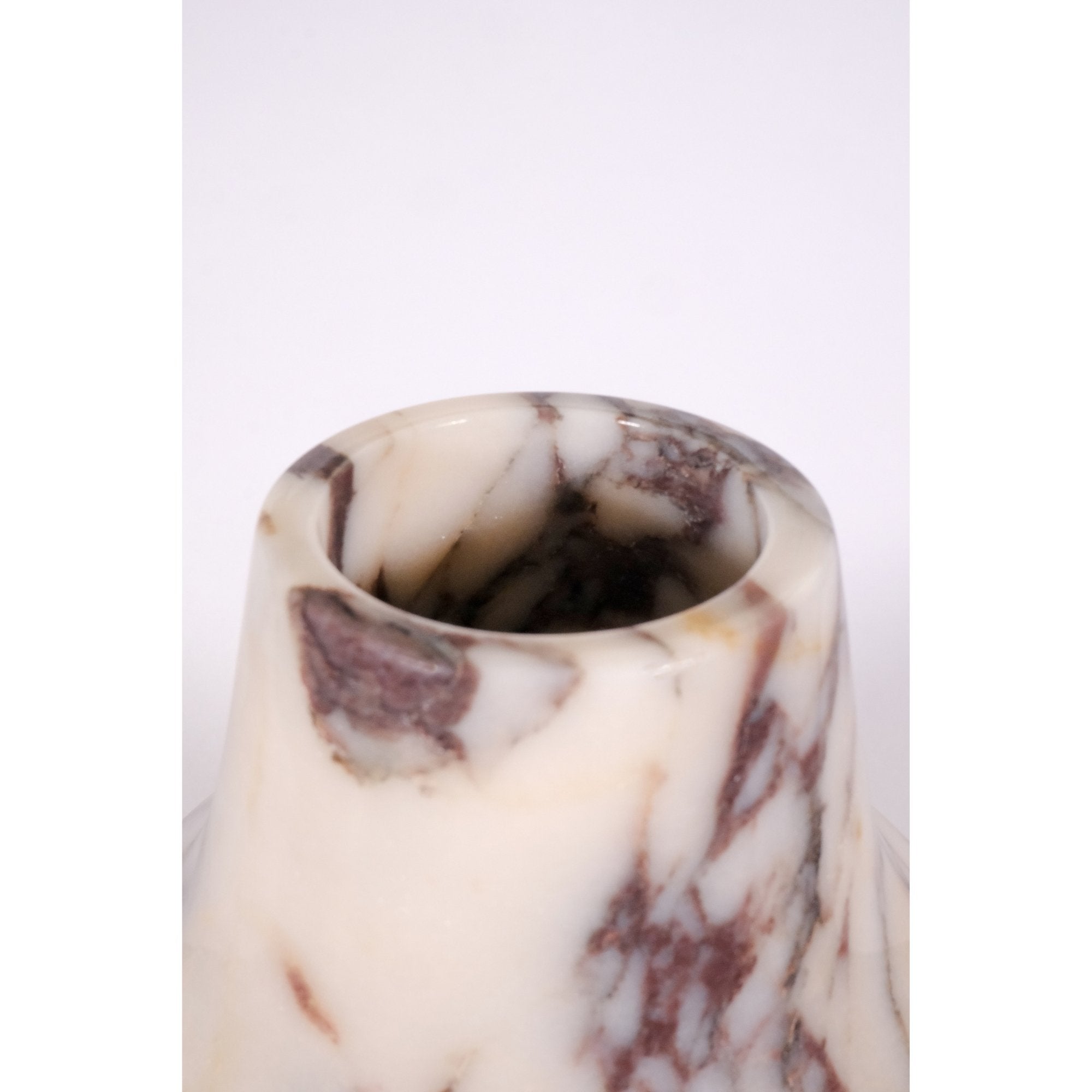 Close-up detail of Calacatta Viola marble vase texture highlighting cream and violet marble patterns.