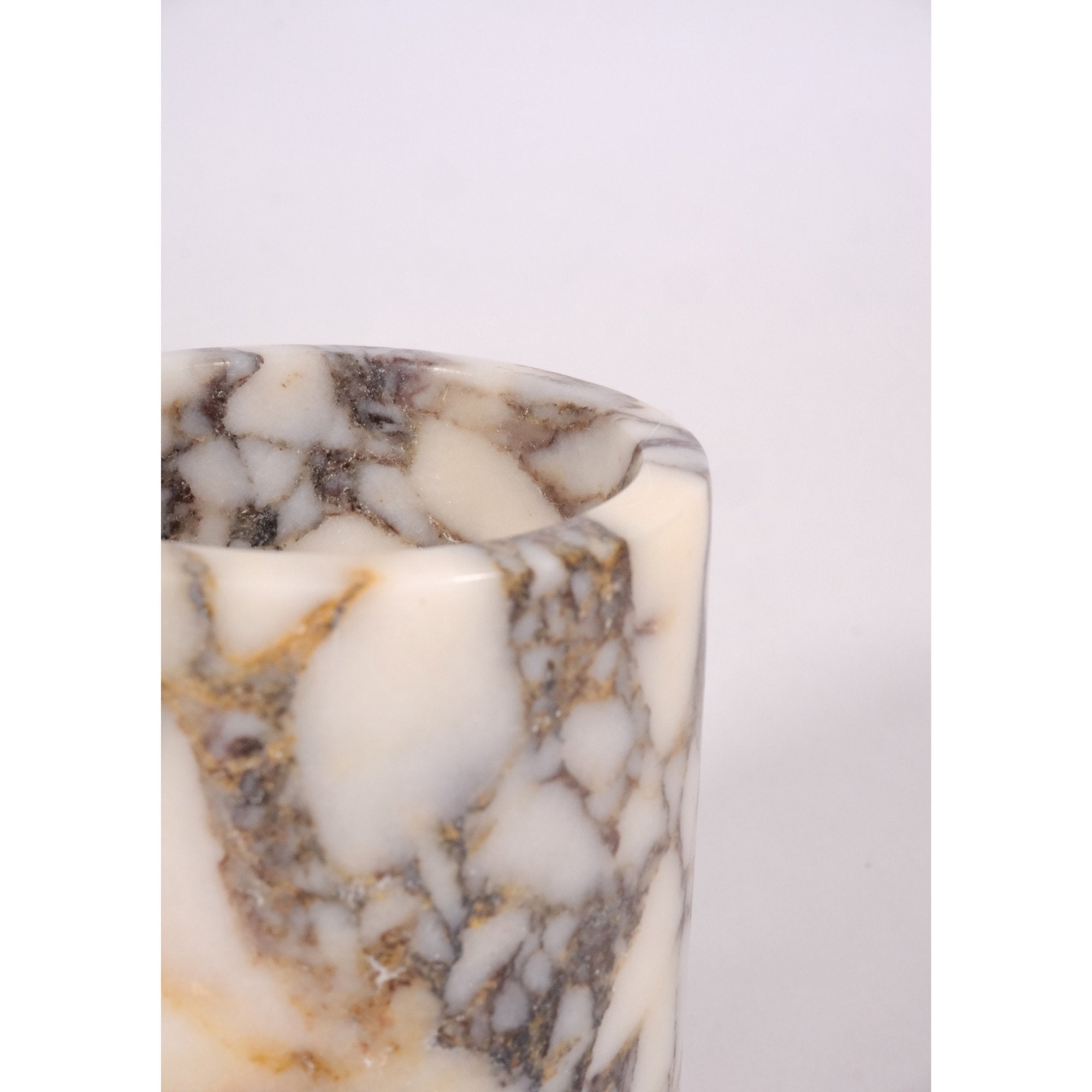 Close-up detail of Calacatta Viola marble texture – fine veining in cream and violet tones, artisan hand-polished finish.