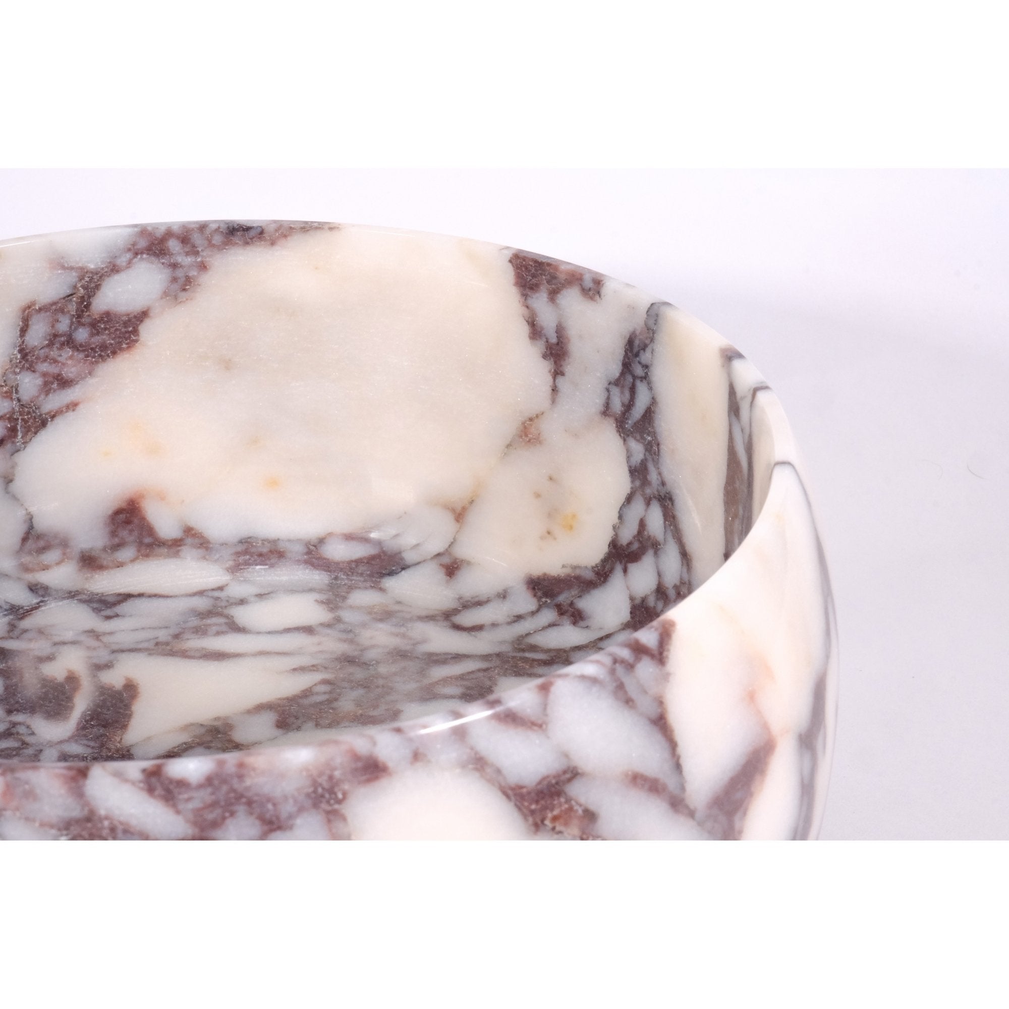 Close-up of polished rim and rich violet webbing on Calacatta Viola marble bowl.