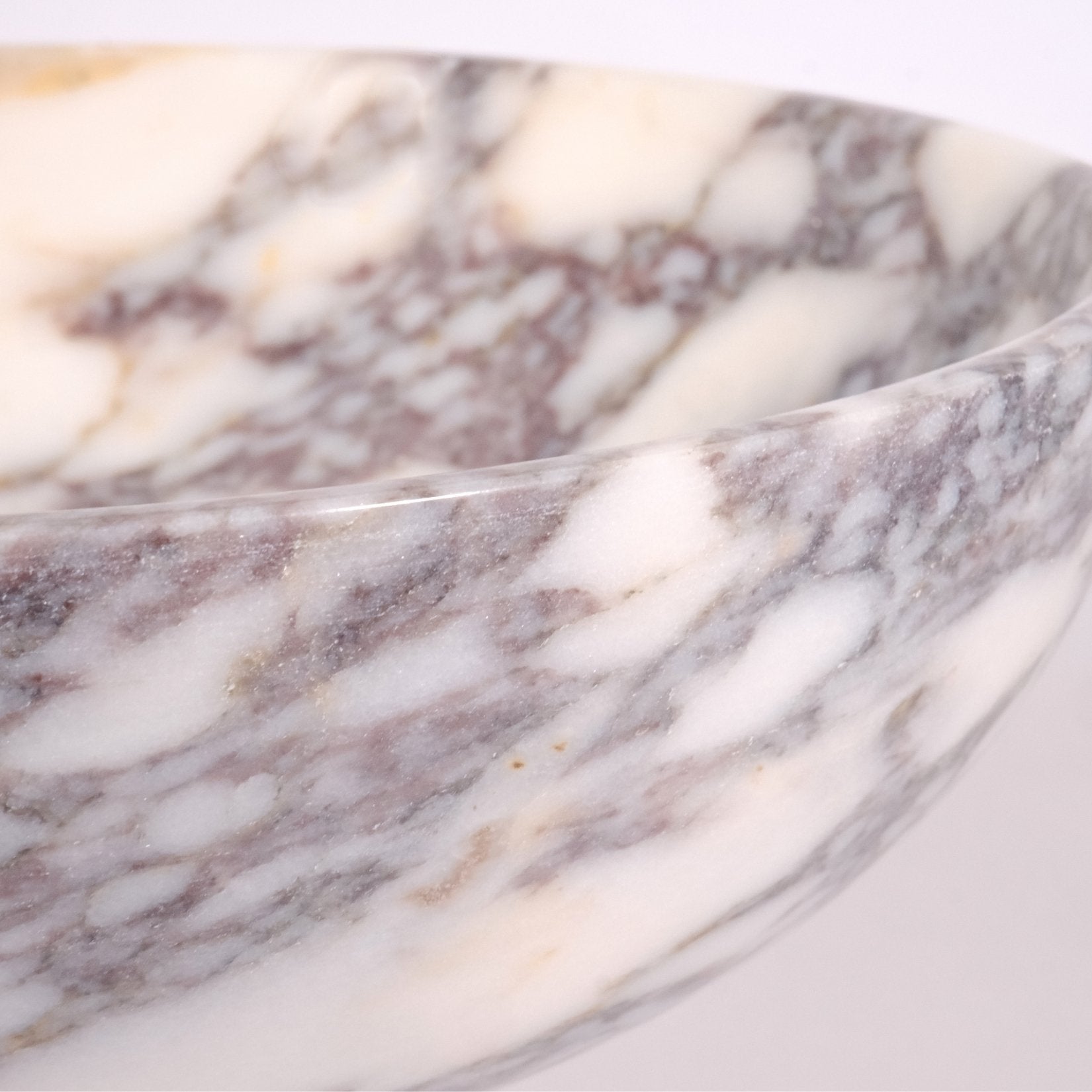Close-up detail of Calacatta Viola marble showing natural veining and polished stone surface