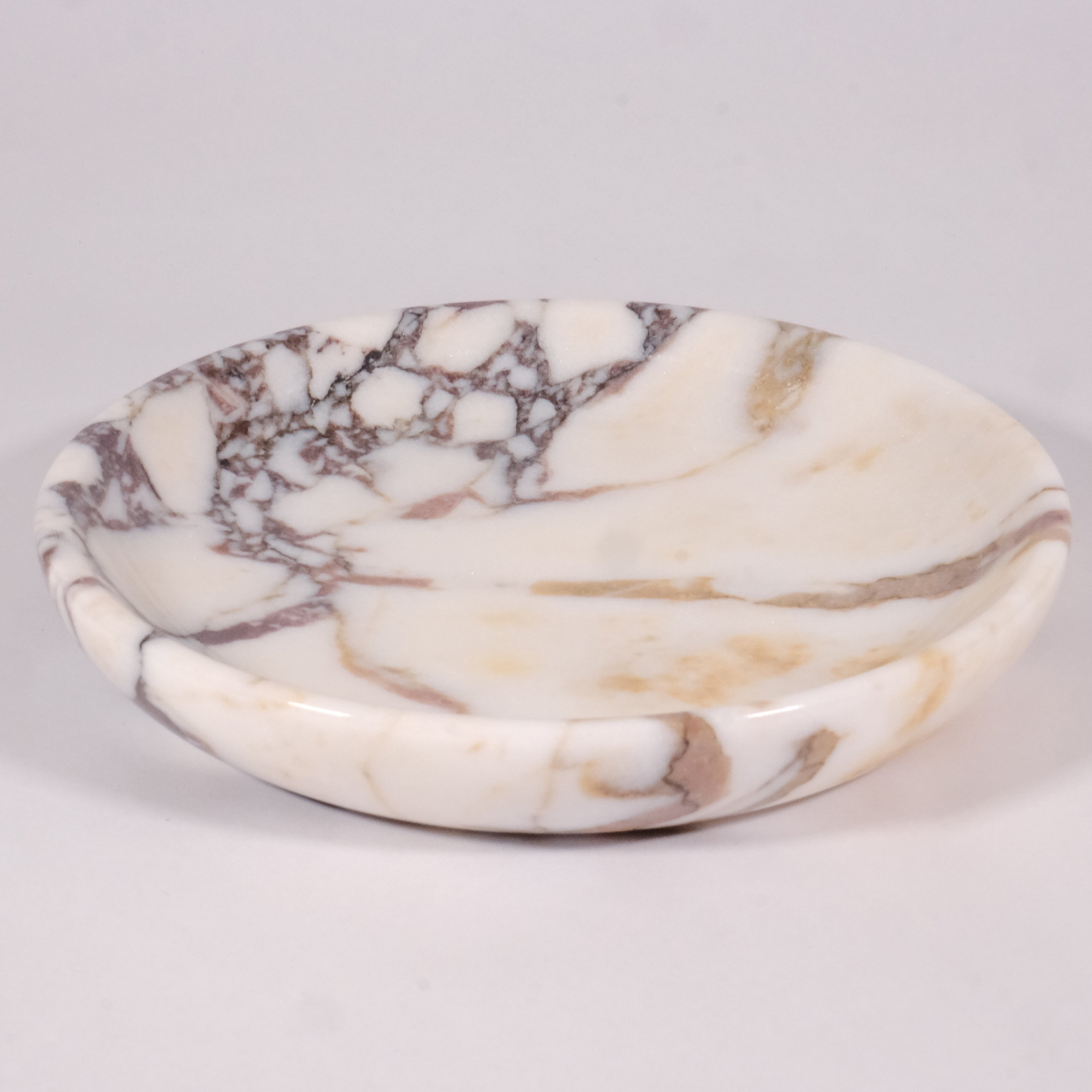 Calacatta Viola marble plate displayed on neutral background, showcasing elegant veining and handcrafted design by Petra Vera.