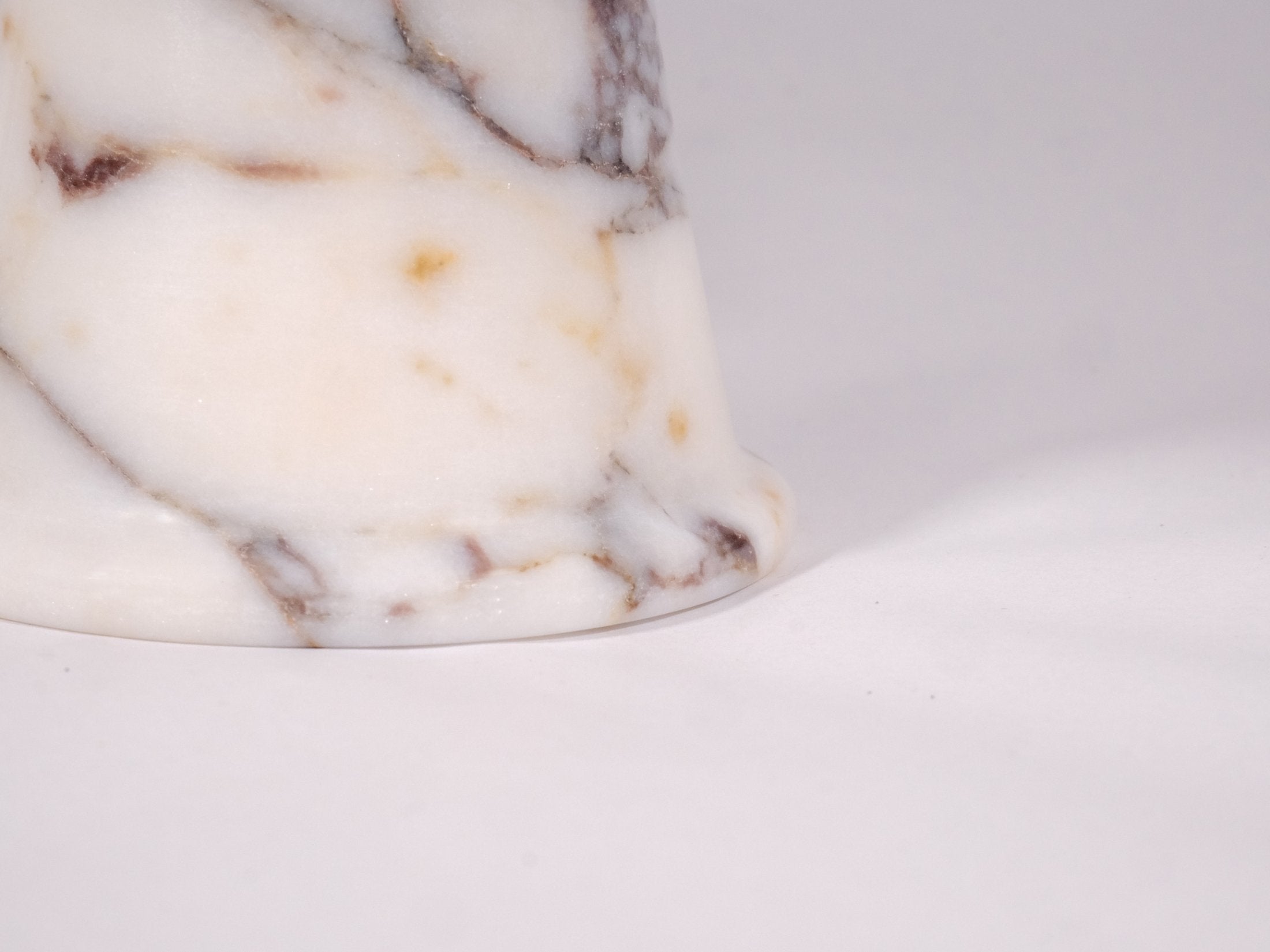 Detailed close-up of Calacatta Viola marble bowl highlighting natural stone texture.