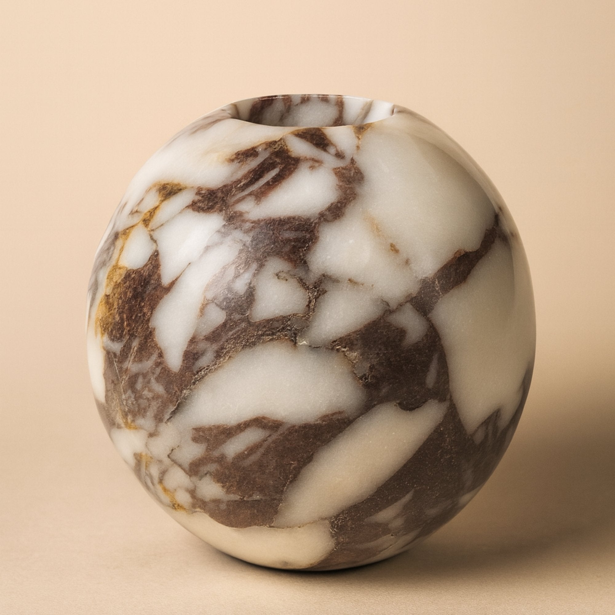 Round Calacatta Viola Marble Vase on a soft beige background, handcrafted from natural stone with deep burgundy and cream veining — luxury home decor by Petra Vera.