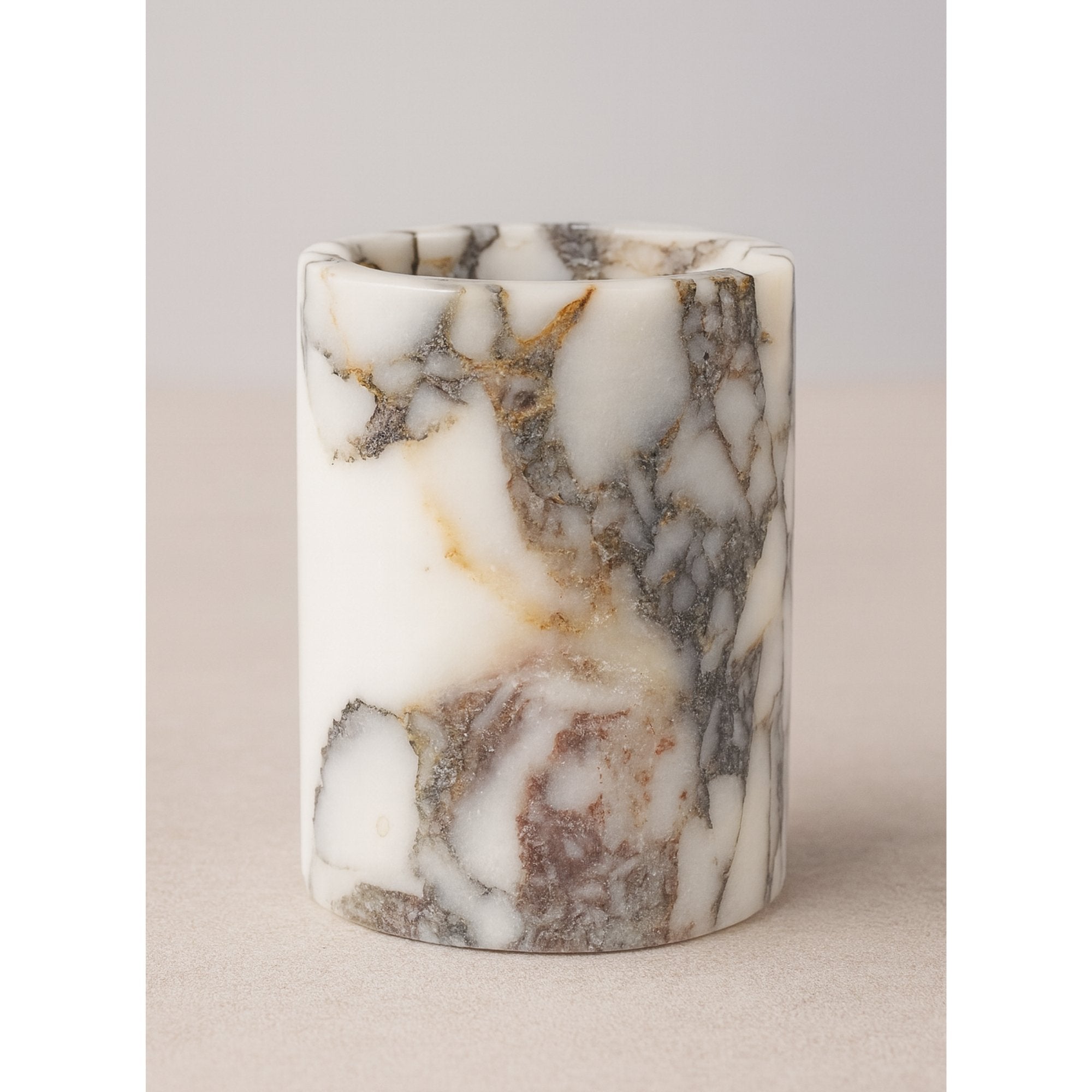 Handcrafted Calacatta Viola marble pen holder on white background – elegant veining, smooth polished surface, minimalist luxury style.