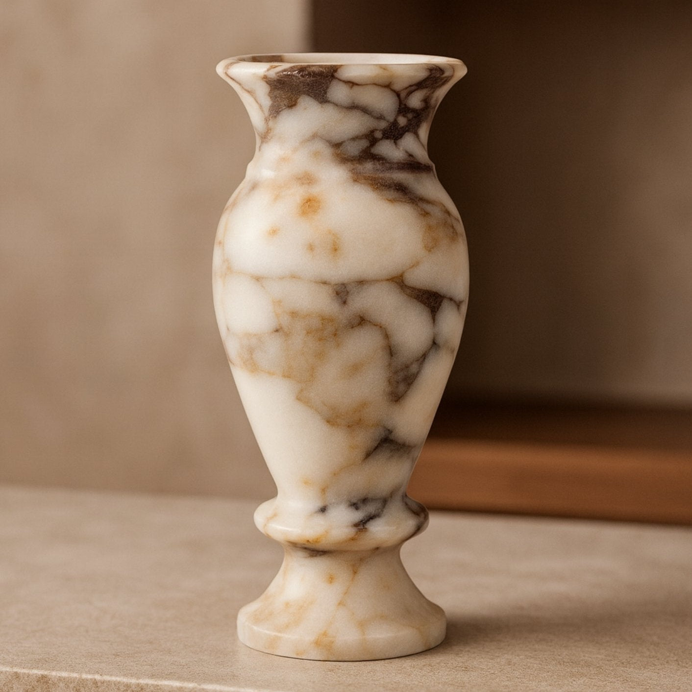 Calacatta Viola marble vase styled on wooden console table – warm interior home styling