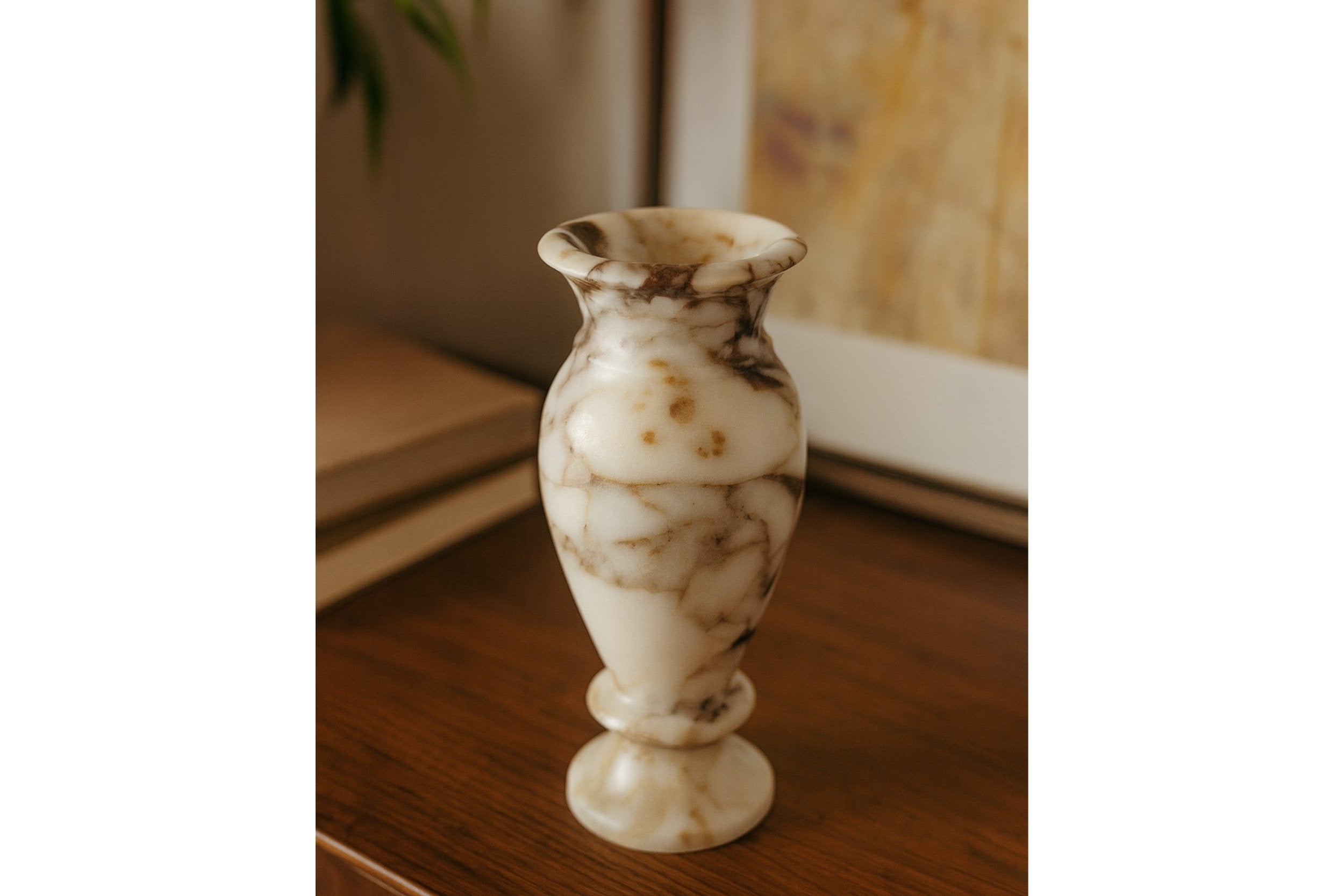 Handcrafted marble vase displayed on beige stone surface in soft natural light – minimalist decor style