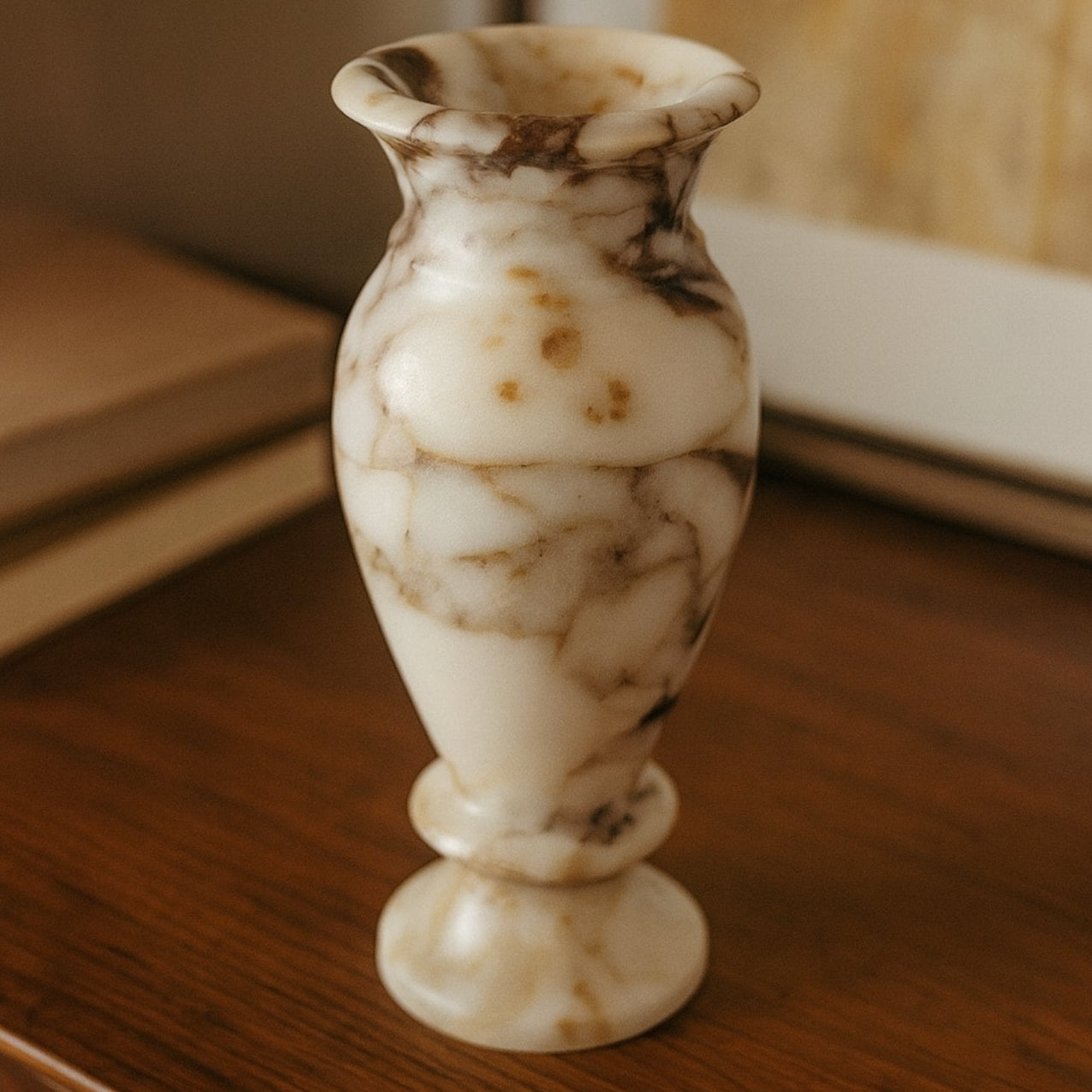 Handcrafted marble vase displayed on beige stone surface in soft natural light – minimalist decor style