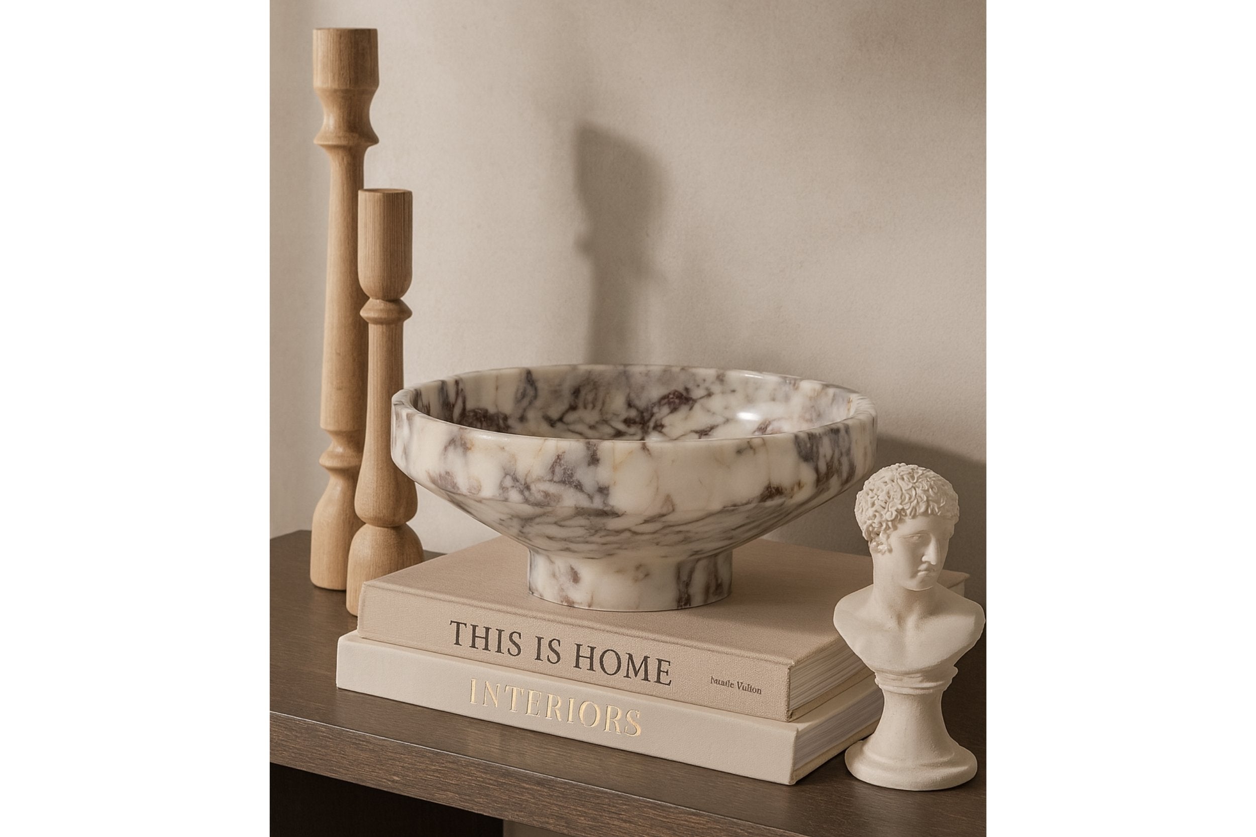 Calacatta Viola marble bowl styled on a neutral stone plinth in soft daylight, modern minimalist interior.
