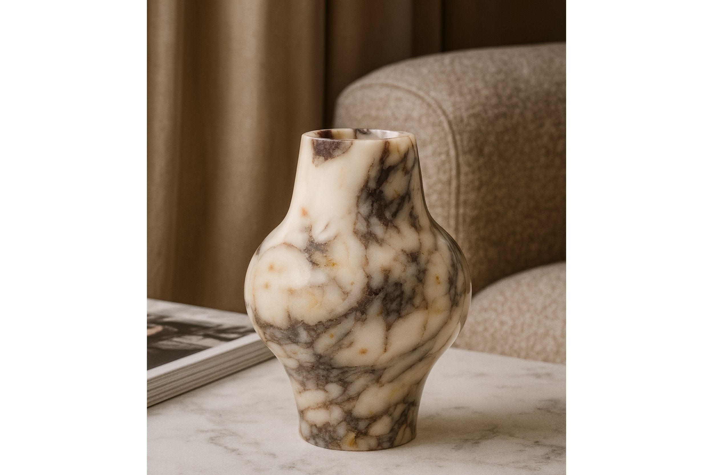 Calacatta Viola marble vase styled on a marble coffee table in an elegant living room setting.