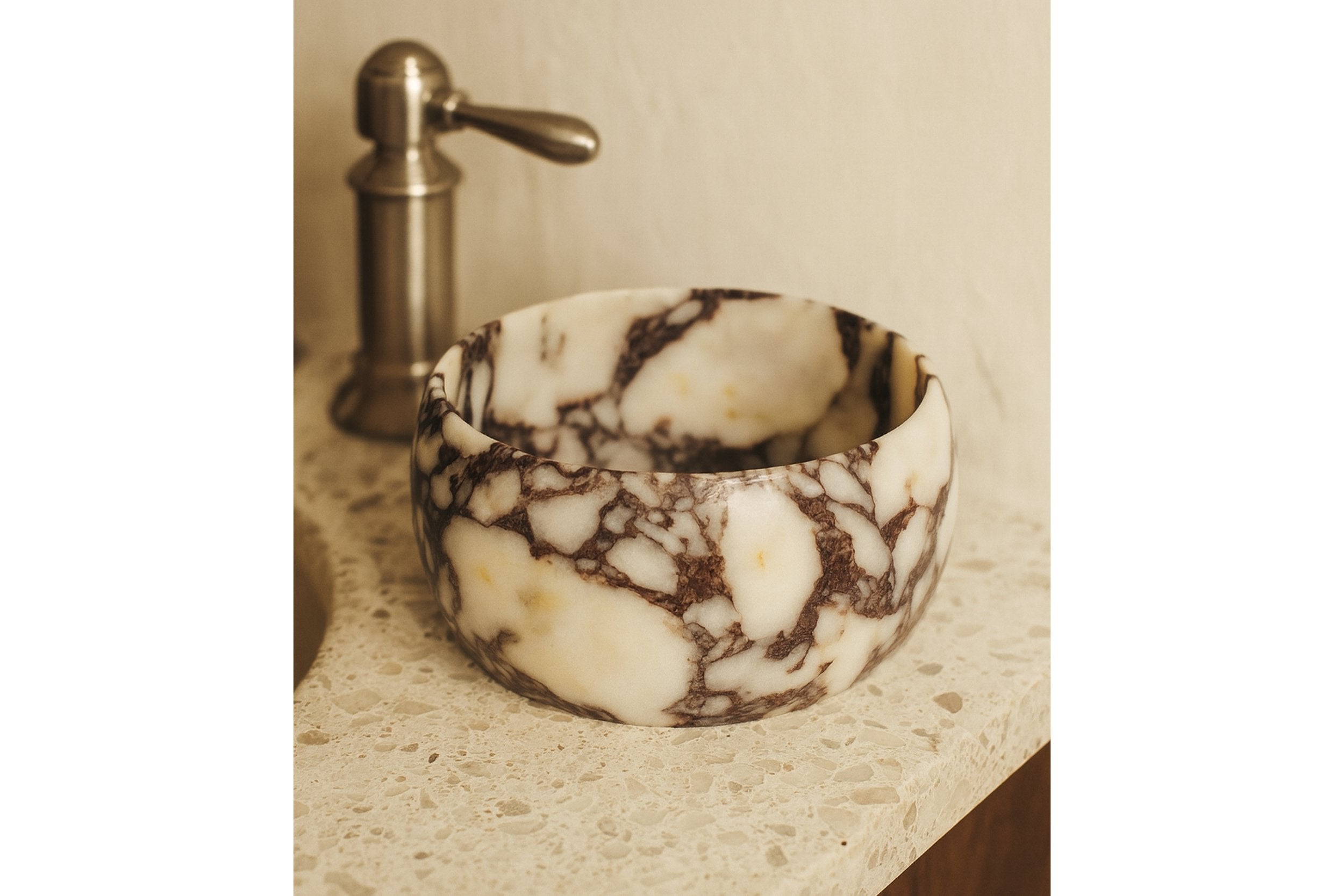 Marble pedestal bowl styled on neutral console, minimalist gallery home décor.