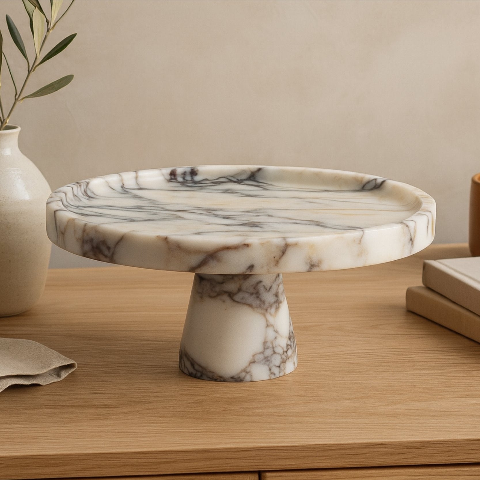 Calacatta Viola marble pedestal bowl on neutral linen runner with Scandinavian decor style