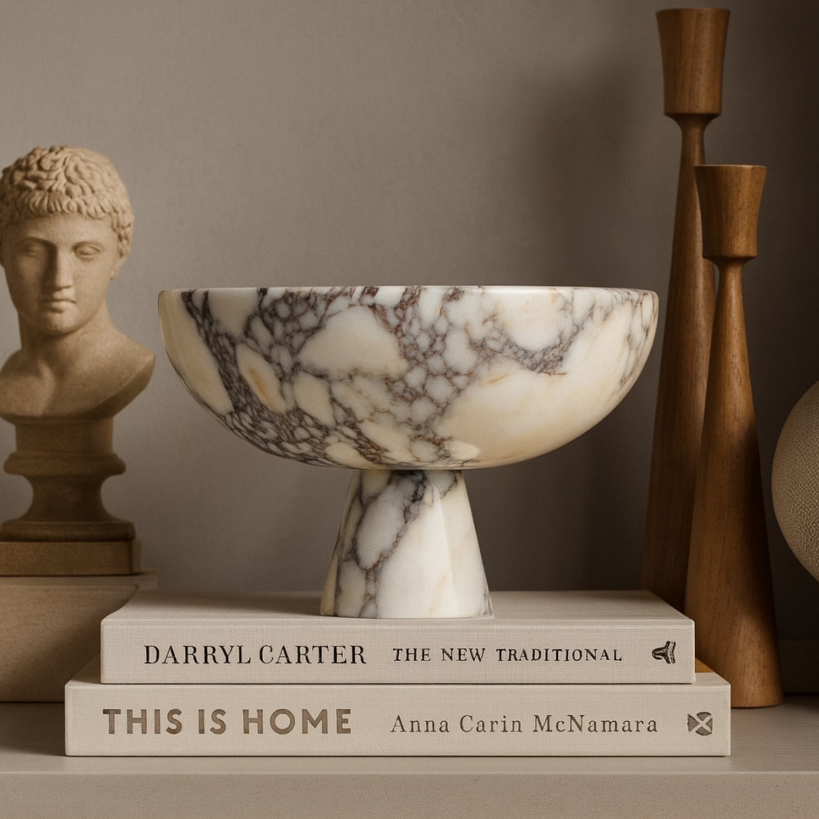 marble pedestal bowl displayed on terrazzo surface with linen fabric and ceramic vase in japandi interior style