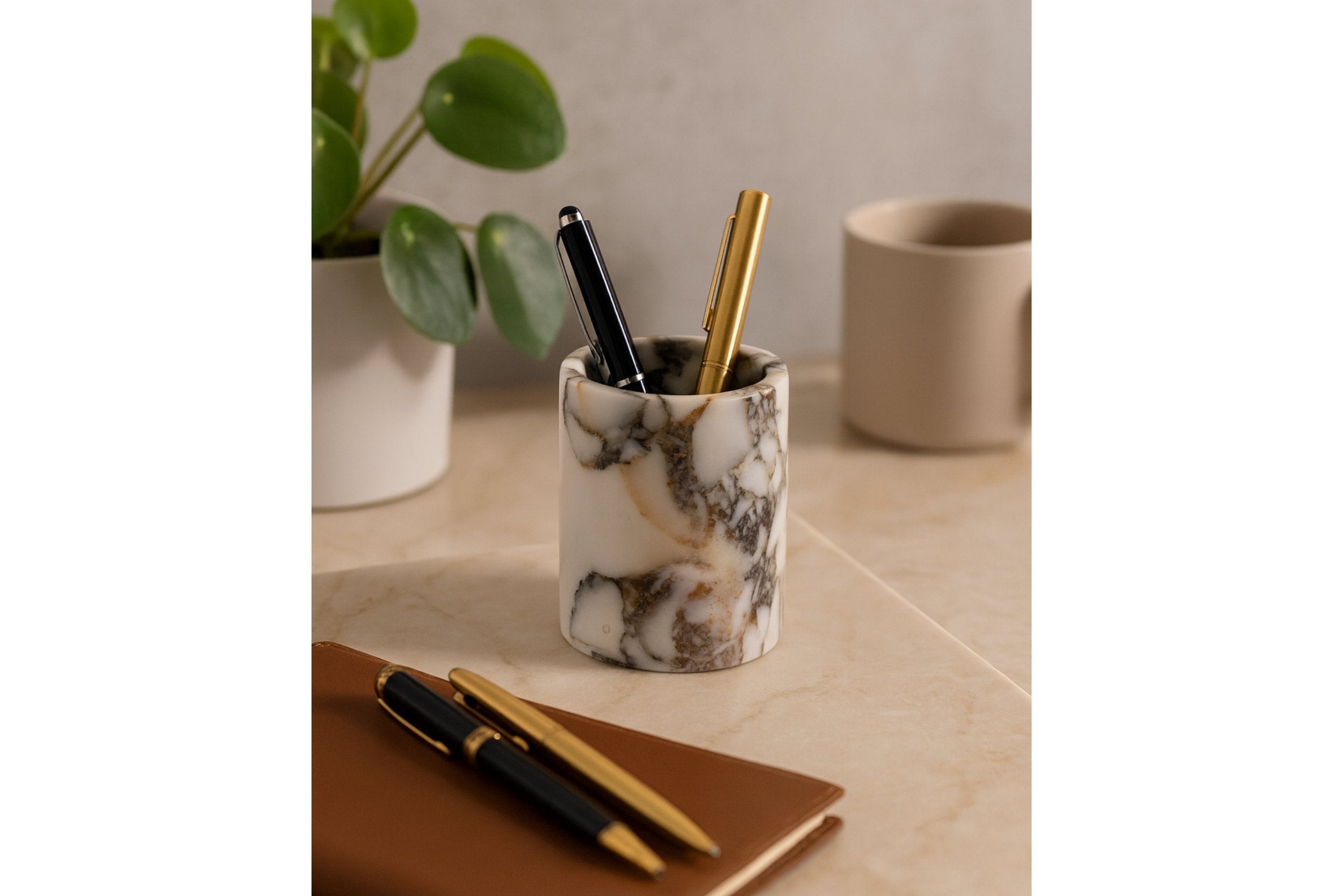 Handcrafted marble pen holder beside books and plants – refined desk organizer with luxurious organic feel.