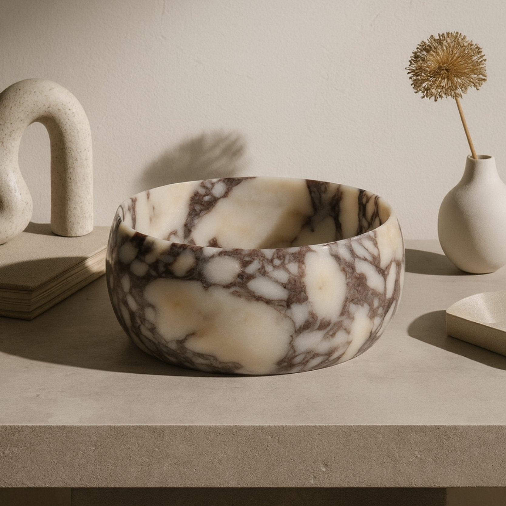 Decorative marble centerpiece bowl on wooden table, cozy modern setting.