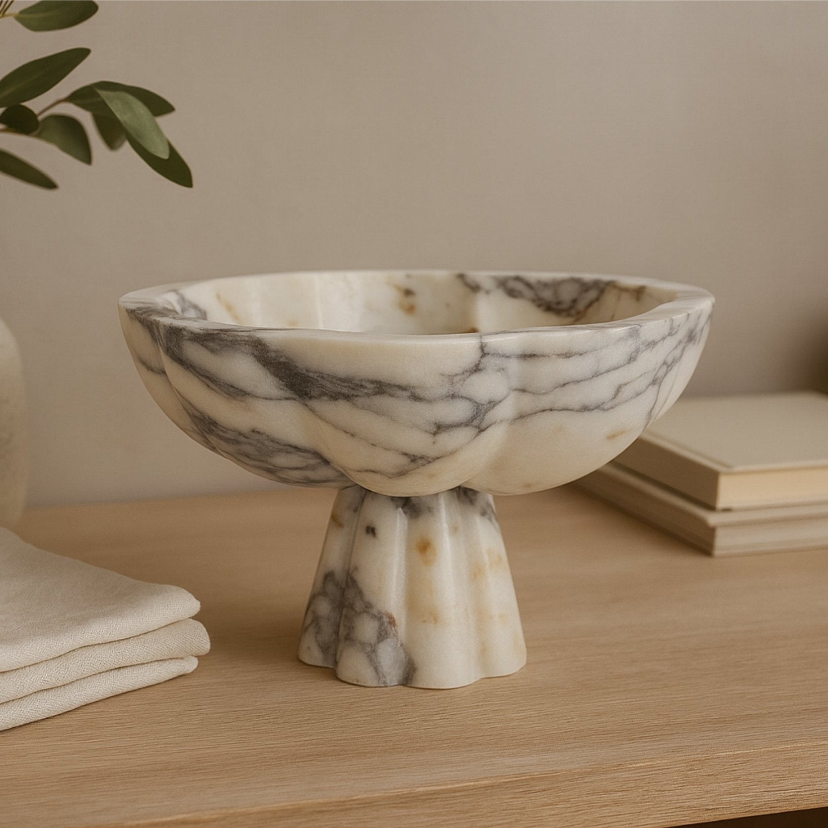 Marble pedestal bowl on wooden surface with natural light — Petra Vera