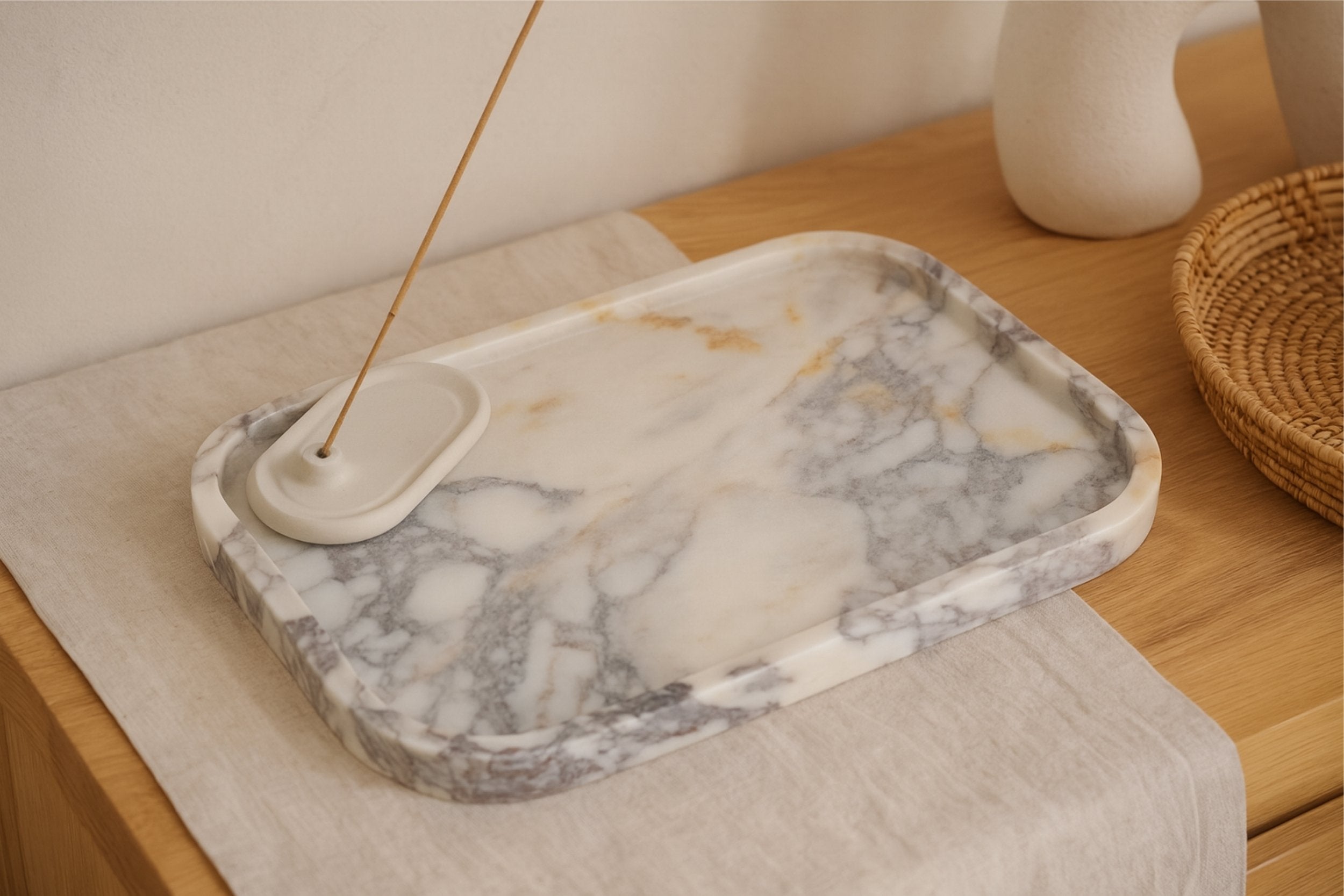 Calacatta Viola marble tray placed on design books for decorative styling in a modern home interior