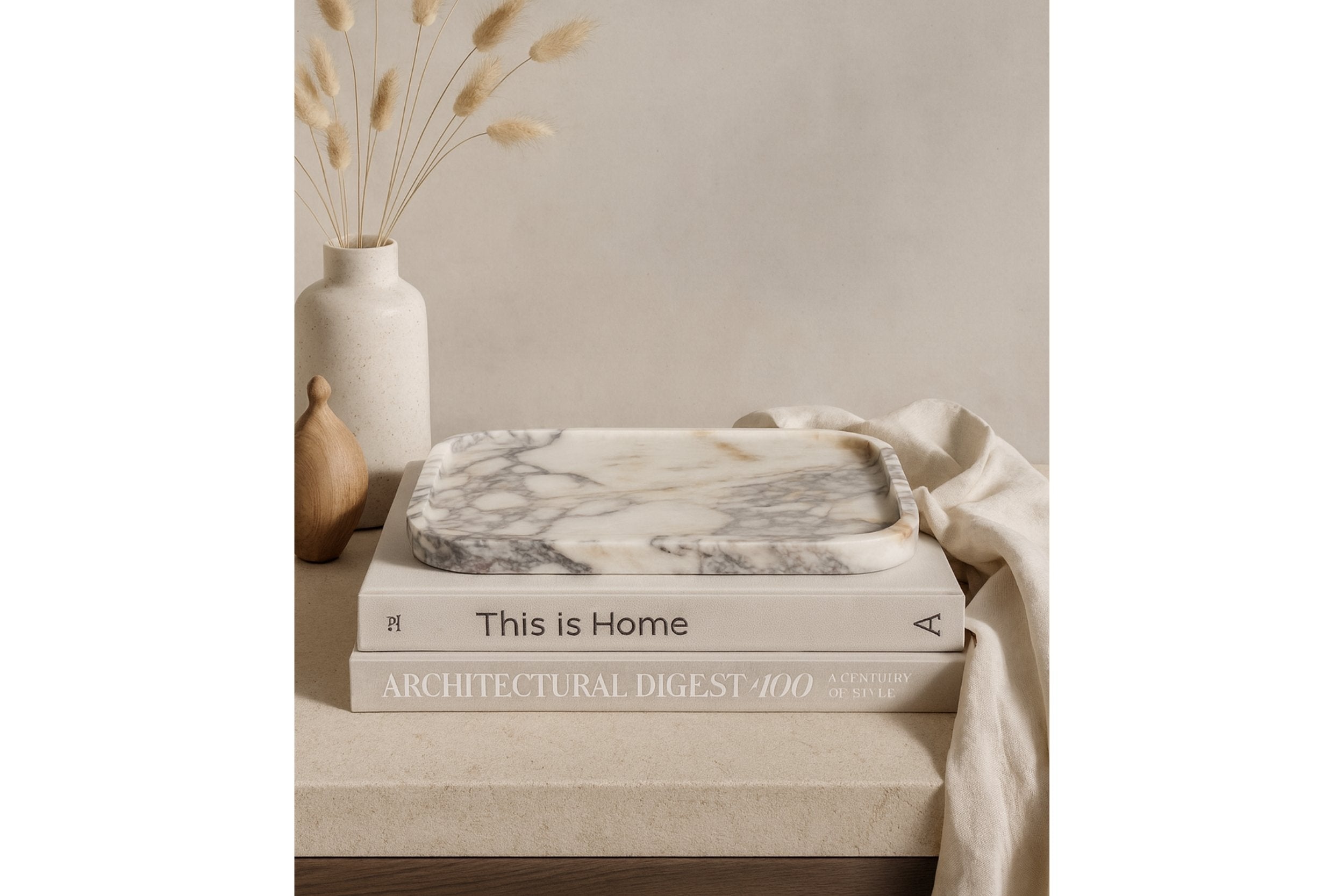 Calacatta Viola marble tray on linen cloth with green plant and neutral tones showcasing everyday use in home decor