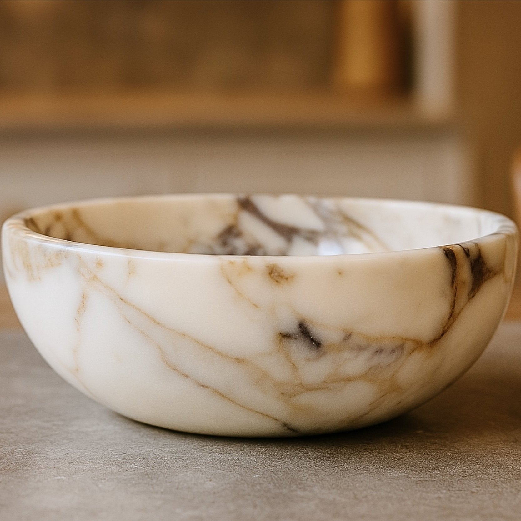 Top view of handcrafted Calacatta Viola marble bowl highlighting its round shape, smooth finish, and luxurious marble veining.