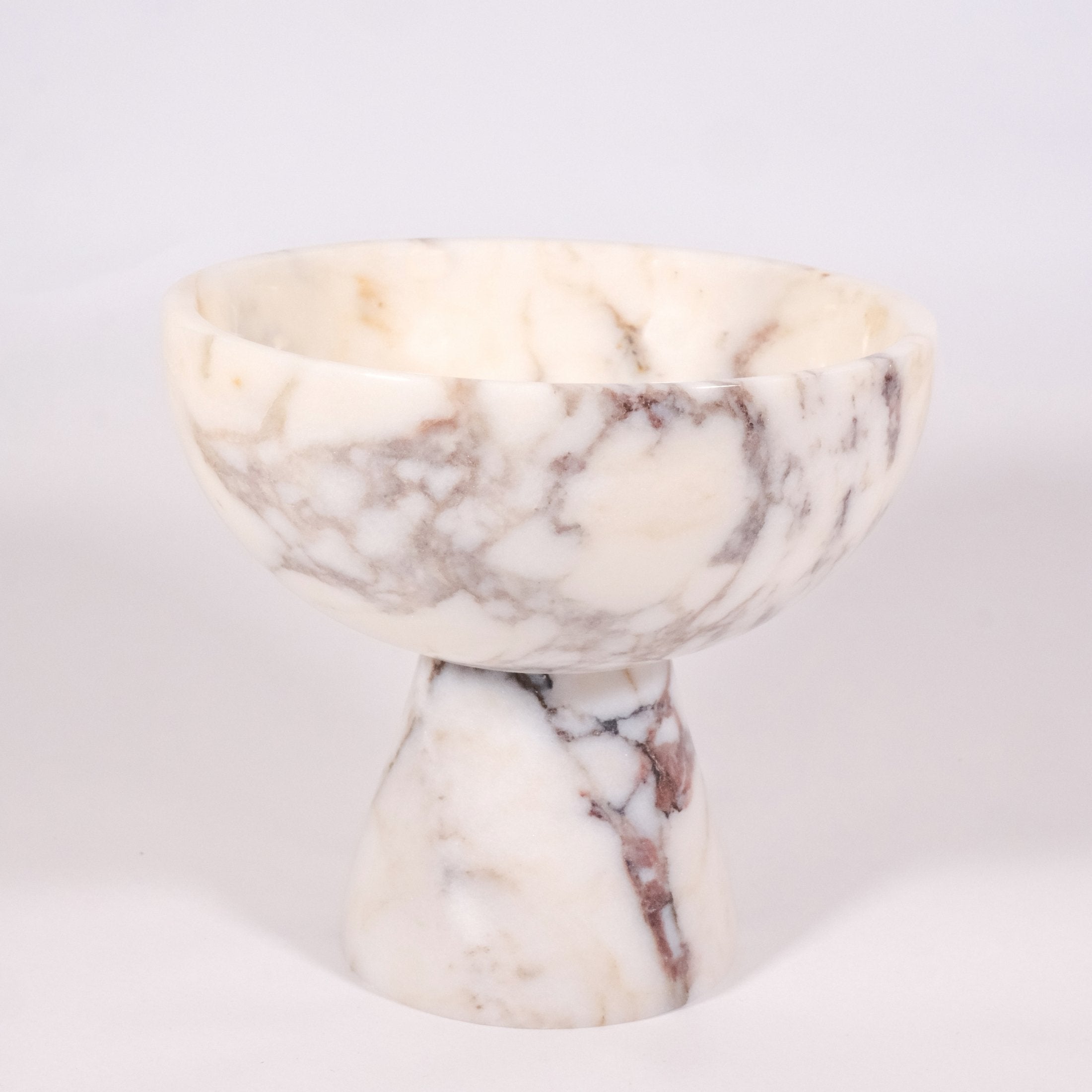 Detailed close-up of Calacatta Viola marble pedestal bowl highlighting texture, craftsmanship, and smooth finish.