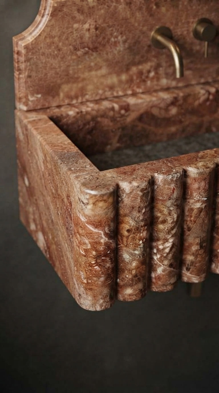 Close-up of Red Travertine sink showing natural stone veining and hand-carved fluted front detail