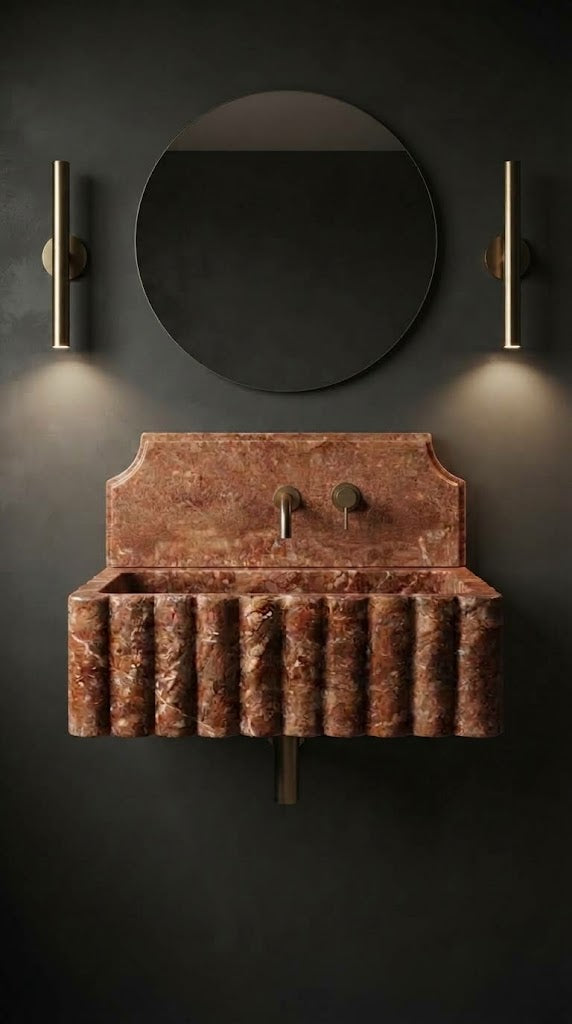 Red Travertine wall mounted sink with sculpted fluted front and decorative backsplash in a luxury bathroom