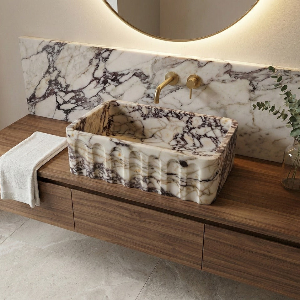 Fluted Calacatta Viola marble sink styled in modern luxury bathroom interior