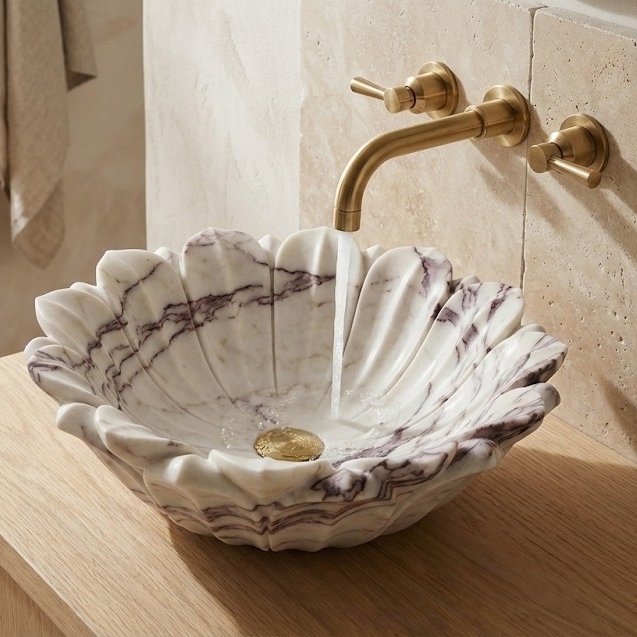 Elegant bathroom interior featuring marble flower vessel sink, luxury sculptural basin design