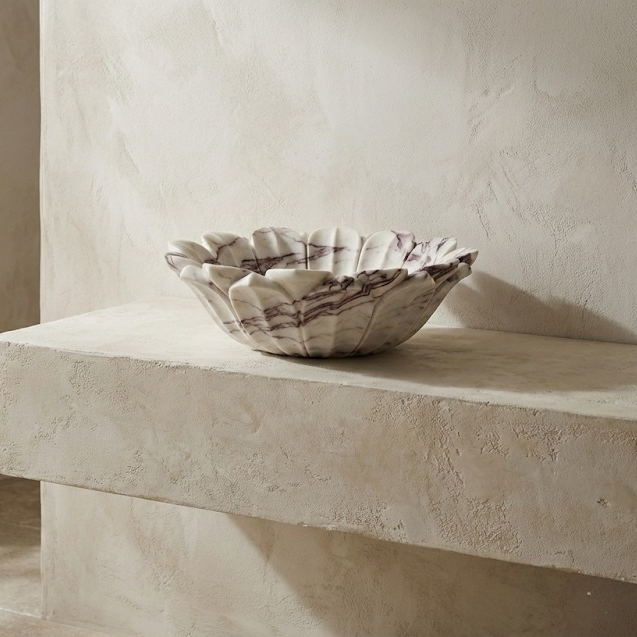 Designer bathroom with artistic marble flower sink, natural stone vessel basin centerpiece