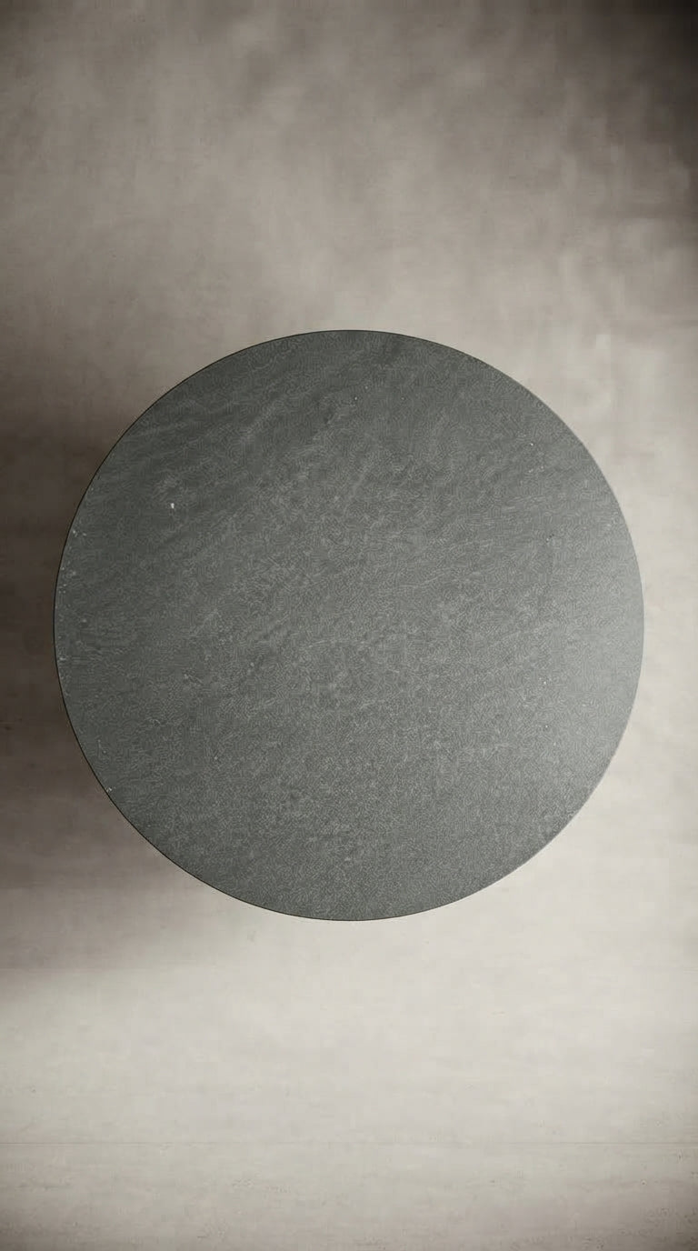 Top view of a 160 cm round Pietra di Cardoso Grigio porcelain tabletop showing its textured grey surface