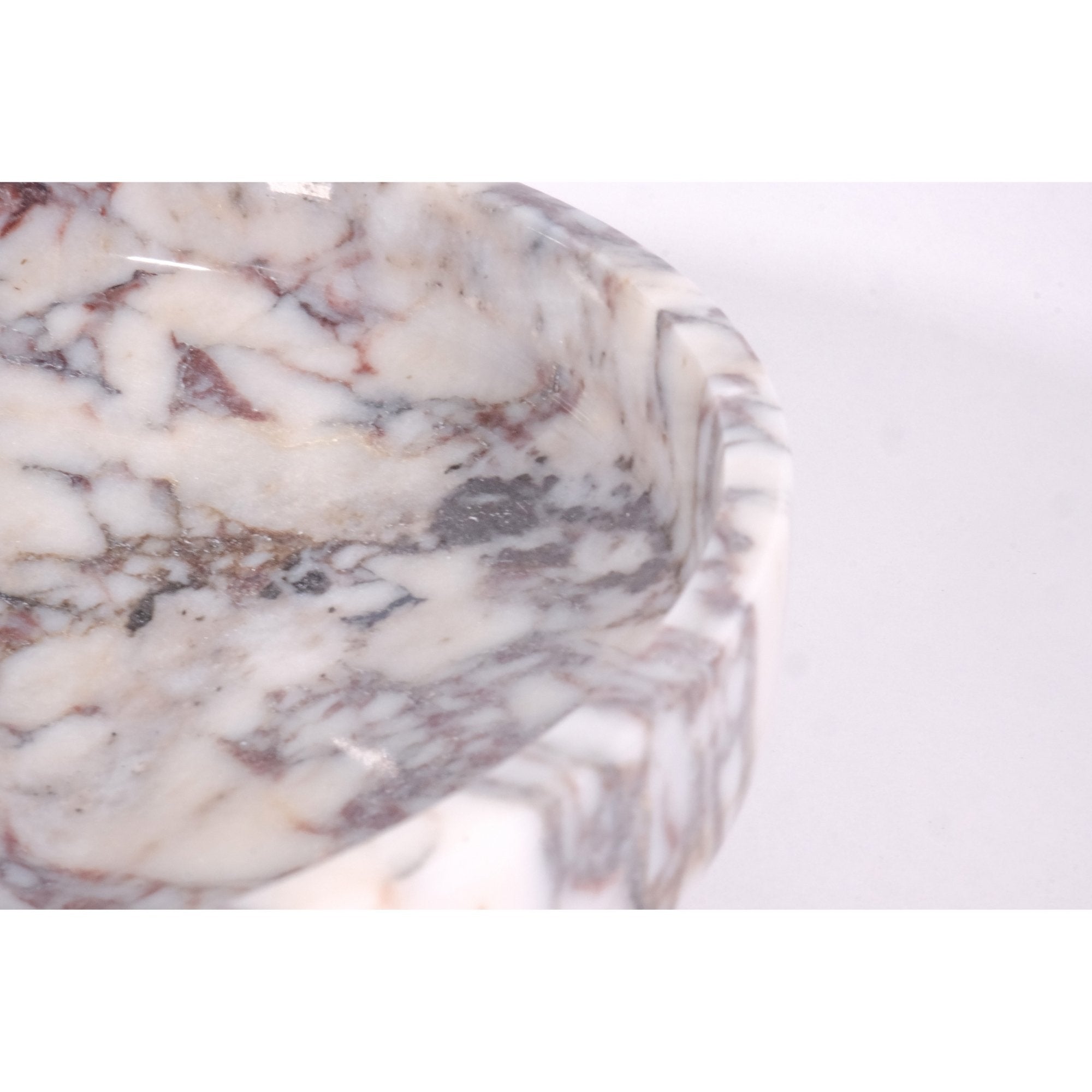 Side angle close-up highlighting the pedestal base and marble texture with elegant finish.