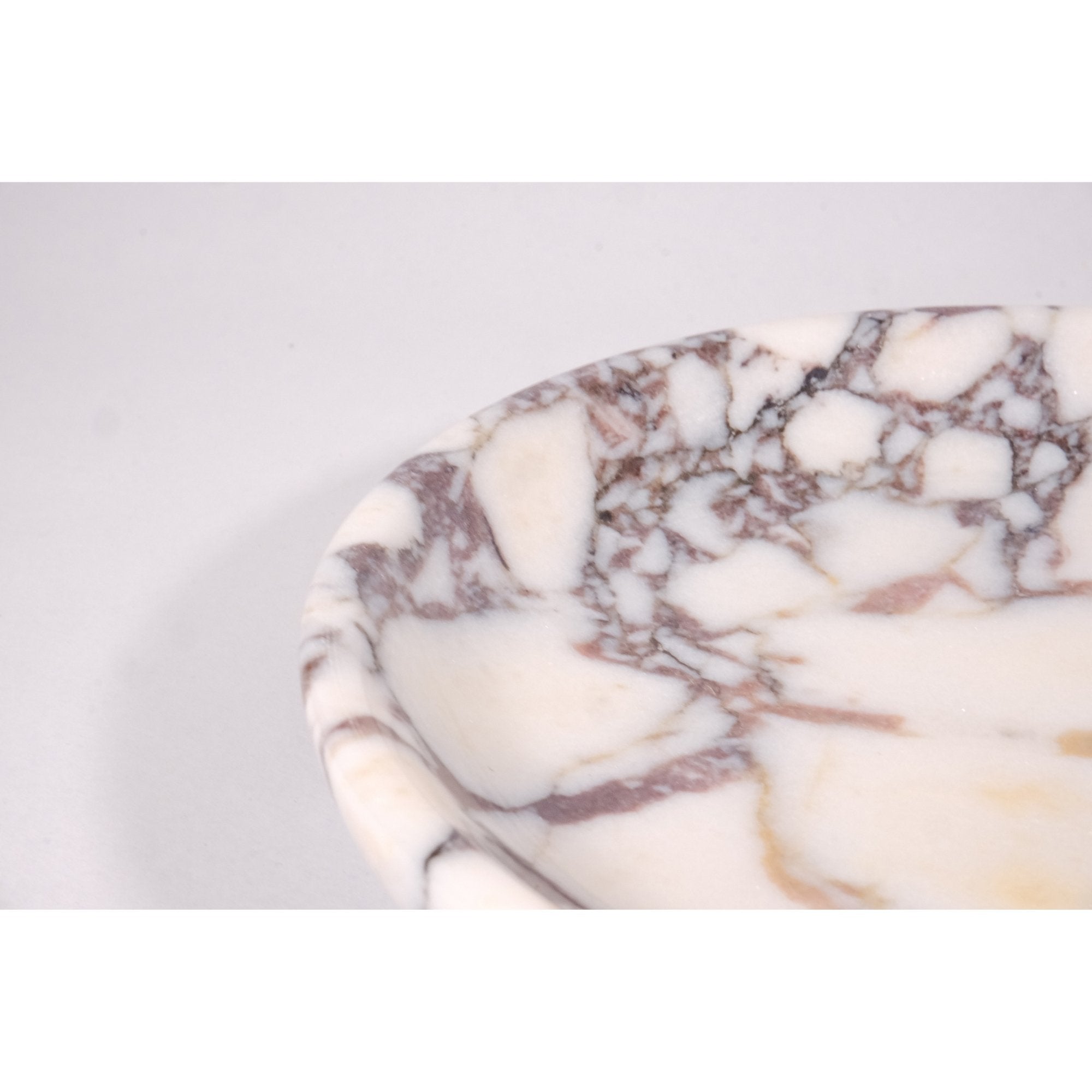 Close-up of Calacatta Viola marble texture showing polished surface and intricate violet and gold veining details.