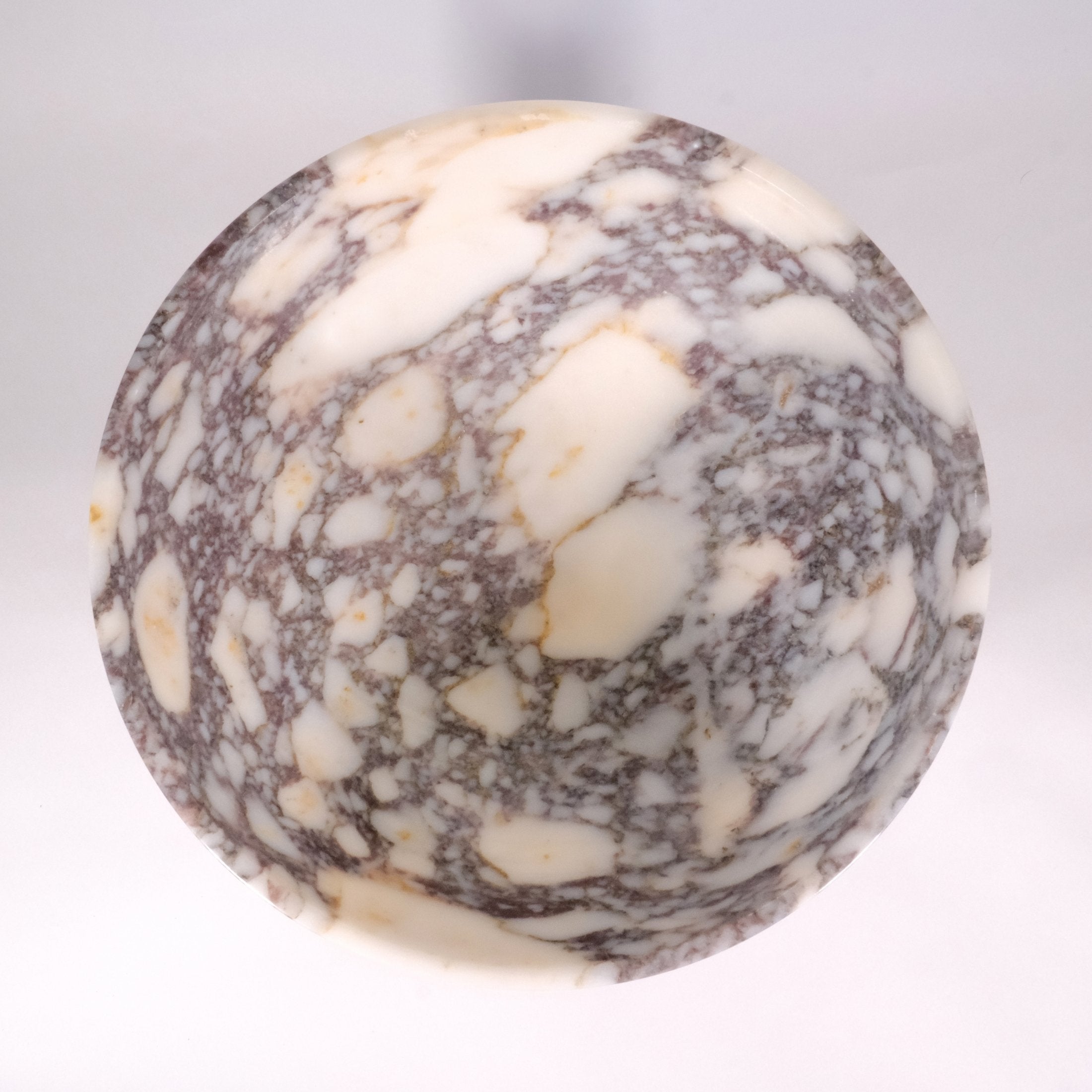 Top view of Calacatta Viola marble bowl showing natural burgundy and ivory veining, Petra Vera.