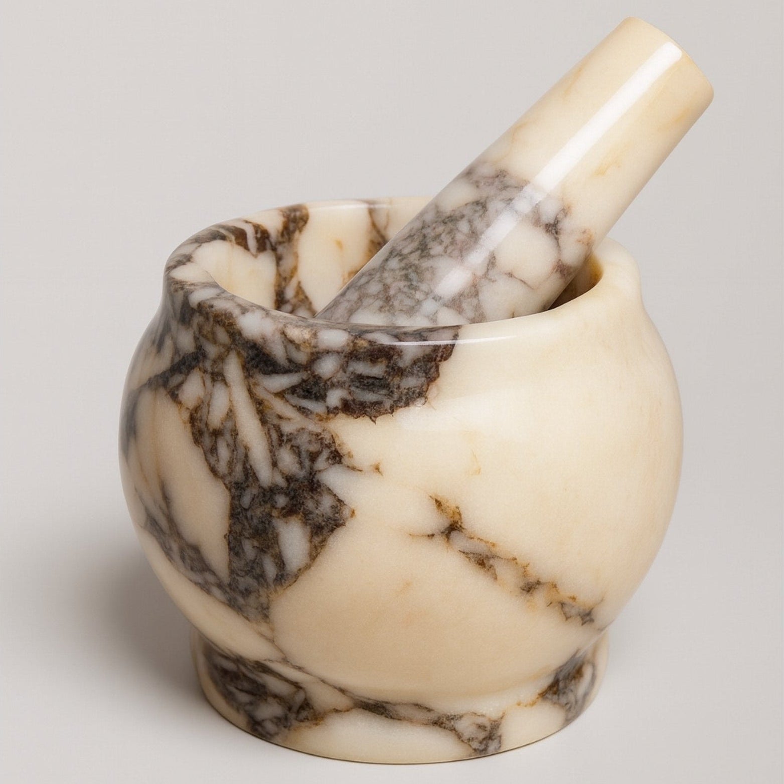 Calacatta Viola marble mortar and pestle set on white background, polished handcrafted kitchen grinder by Petra Vera.