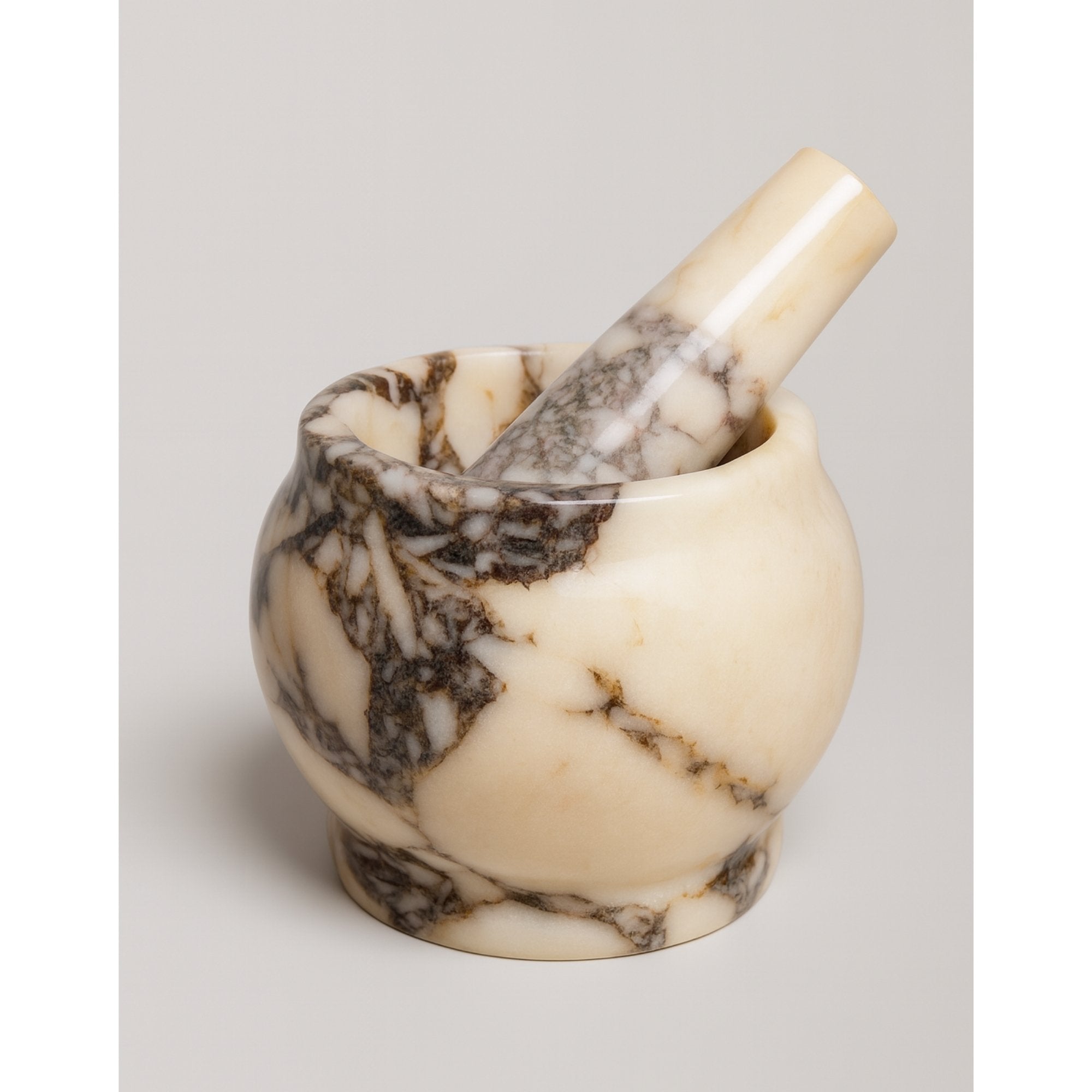 Calacatta Viola marble mortar and pestle set on white background, polished handcrafted kitchen grinder by Petra Vera.
