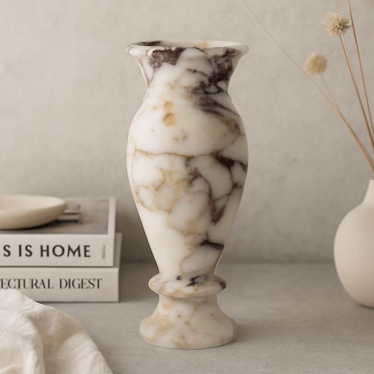 Tall marble vase with dried branches on neutral wooden shelf – Japandi inspired home decor