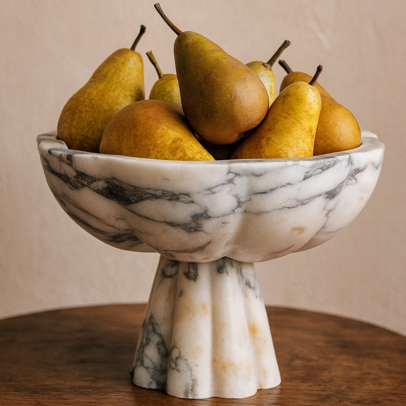 Calacatta Viola marble pedestal bowl styled with pears on wooden table — Petra Vera