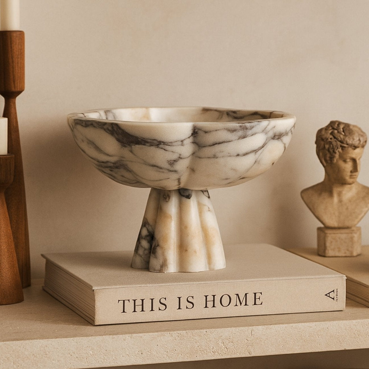 Calacatta Viola marble bowl displayed on “This Is Home” book — Petra Vera