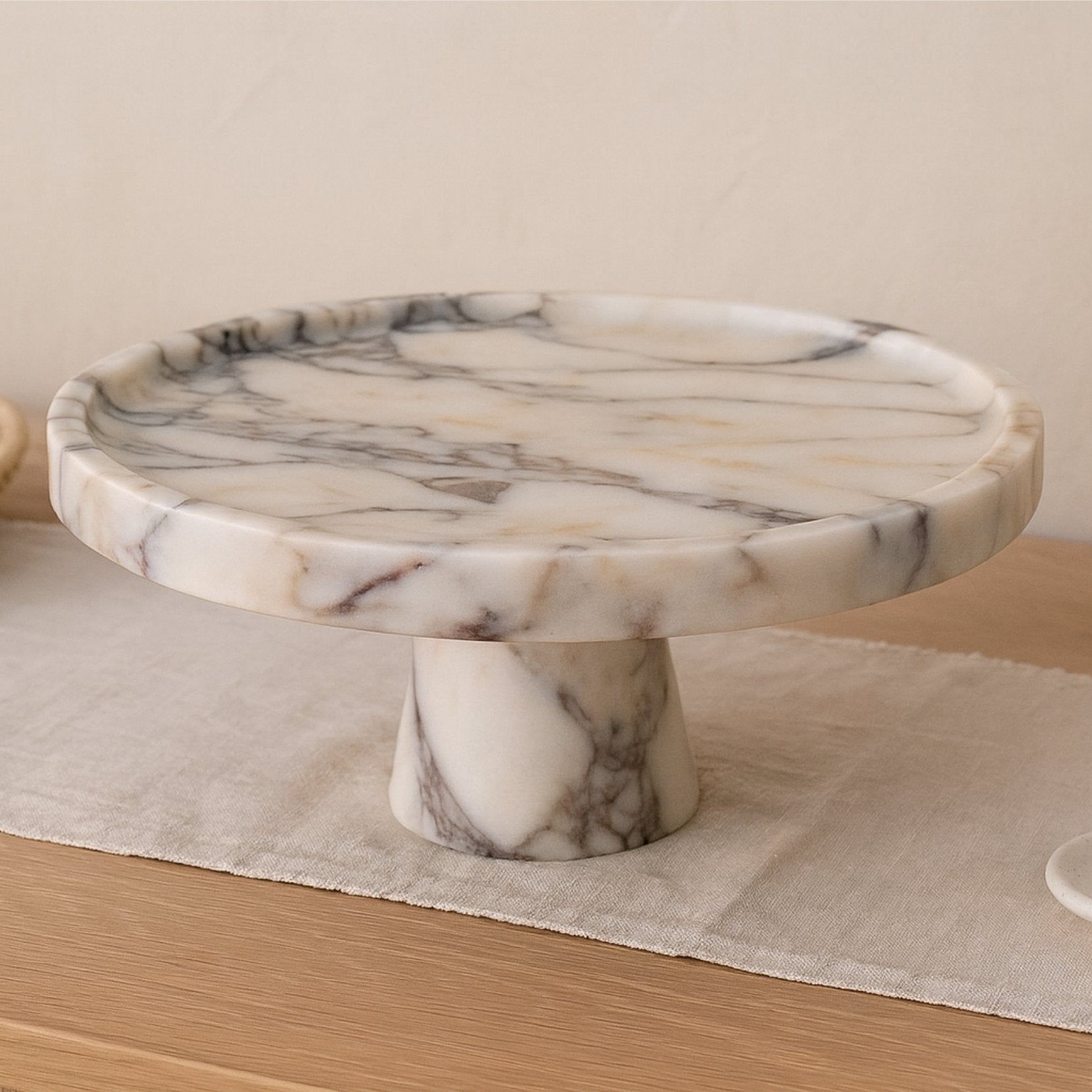 Modern minimalist interior with Calacatta Viola marble serving bowl, soft daylight and sculptural decor elements