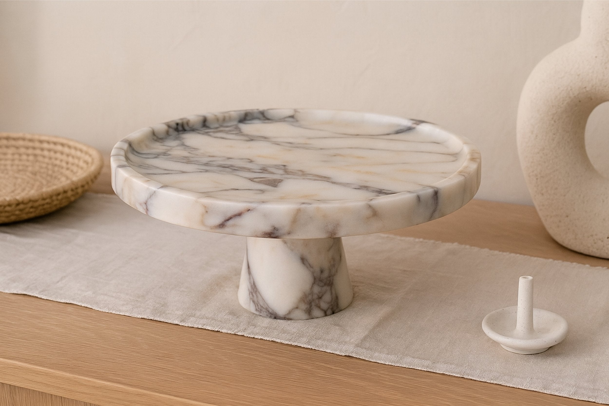 Modern minimalist interior with Calacatta Viola marble serving bowl, soft daylight and sculptural decor elements