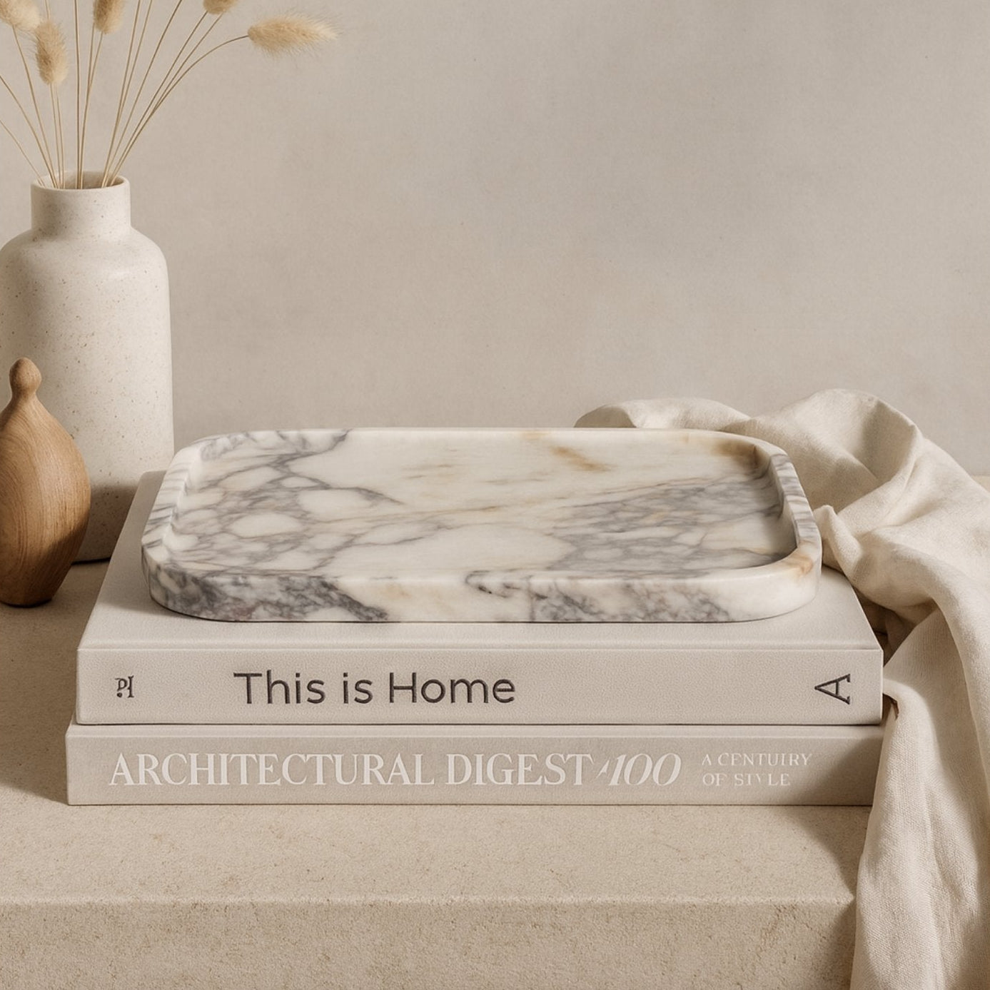 Calacatta Viola marble tray on linen cloth with green plant and neutral tones showcasing everyday use in home decor