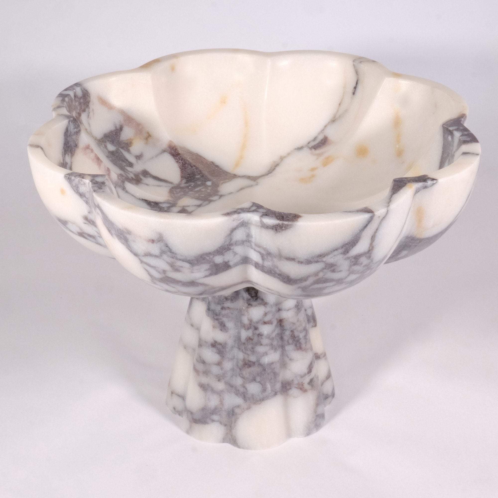 Top view of Calacatta Viola marble bowl showing scalloped rim and natural veining