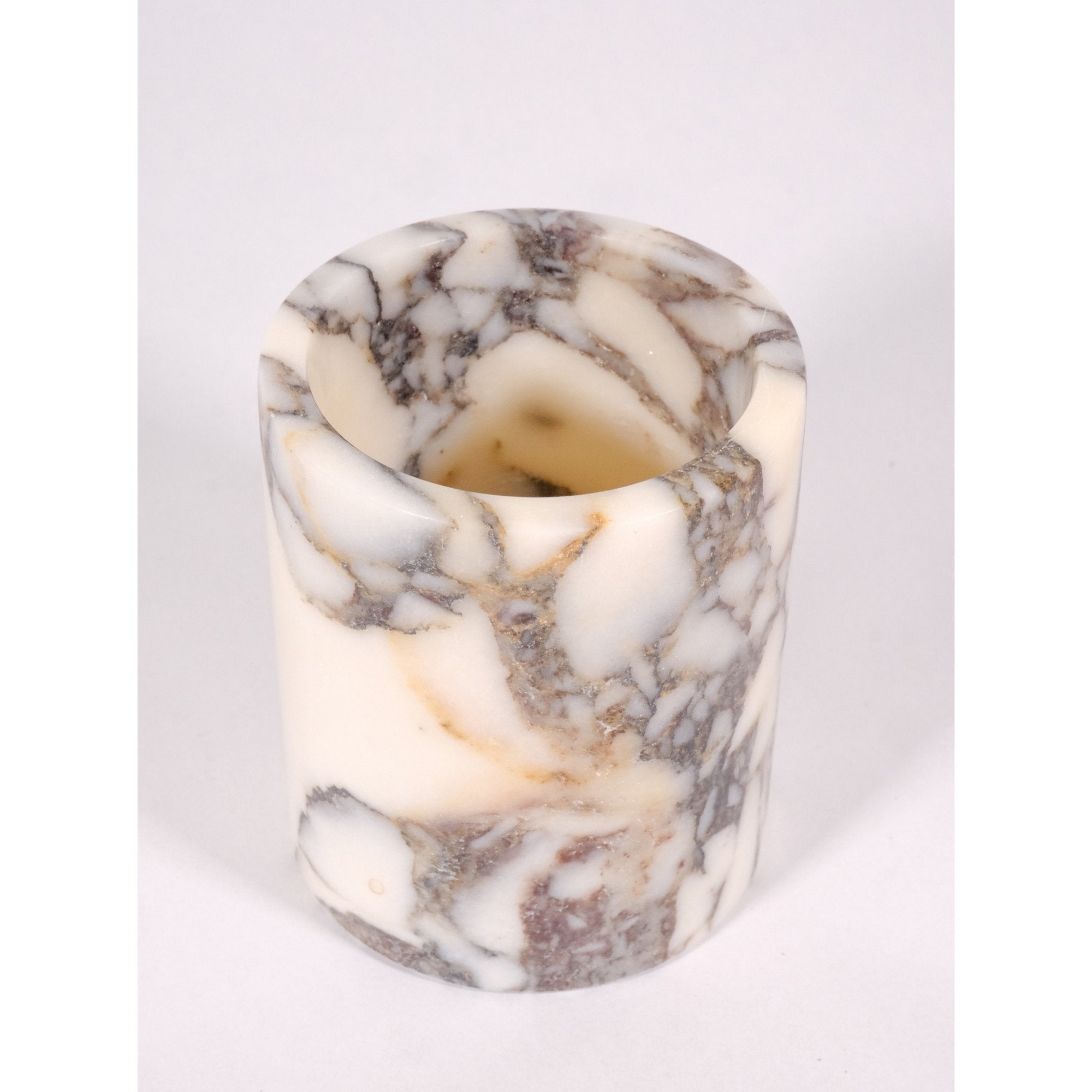 Top view of Turkish Calacatta Viola marble pen holder showing circular form, detailed interior polish, and natural marble pattern.
