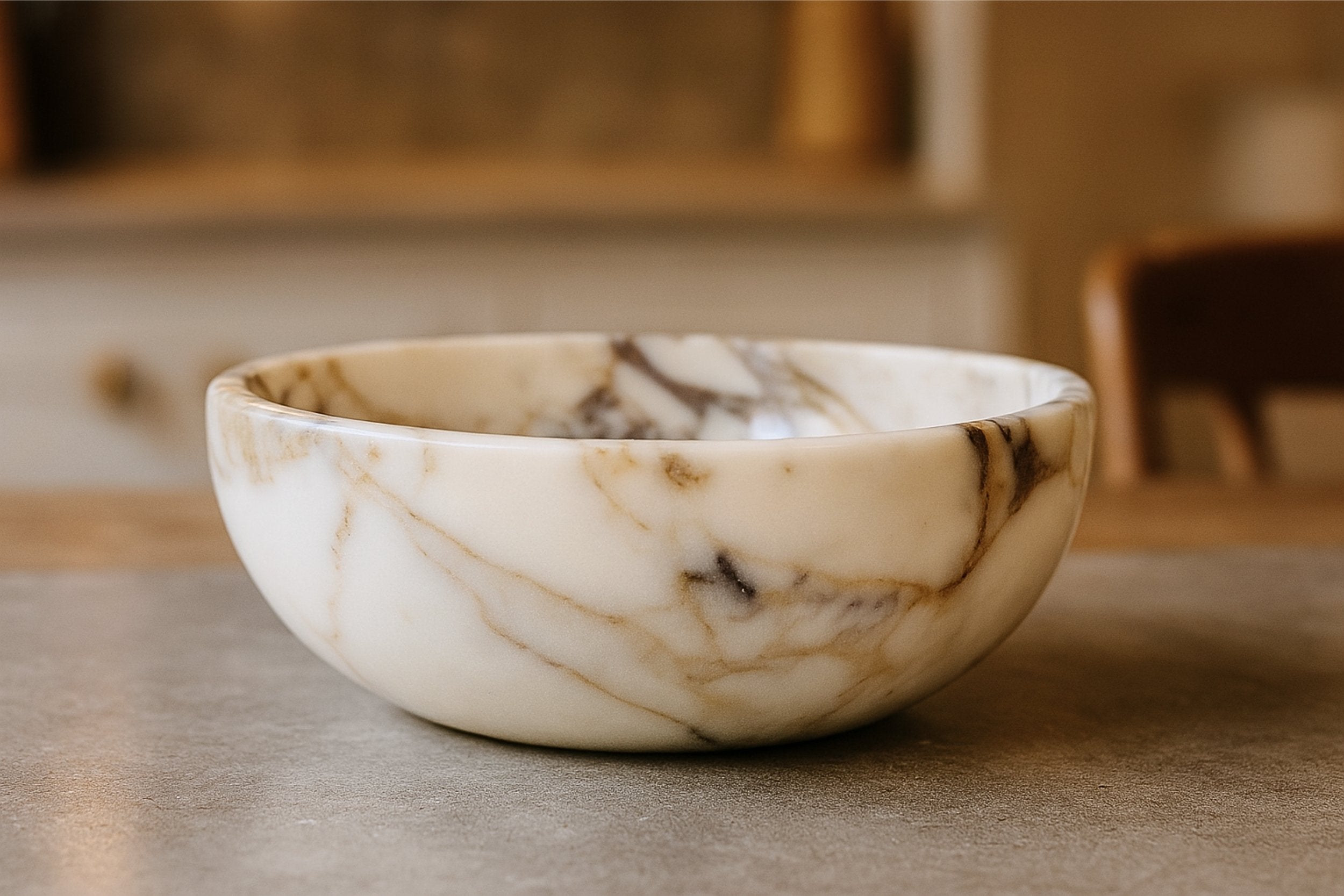 Top view of handcrafted Calacatta Viola marble bowl highlighting its round shape, smooth finish, and luxurious marble veining.