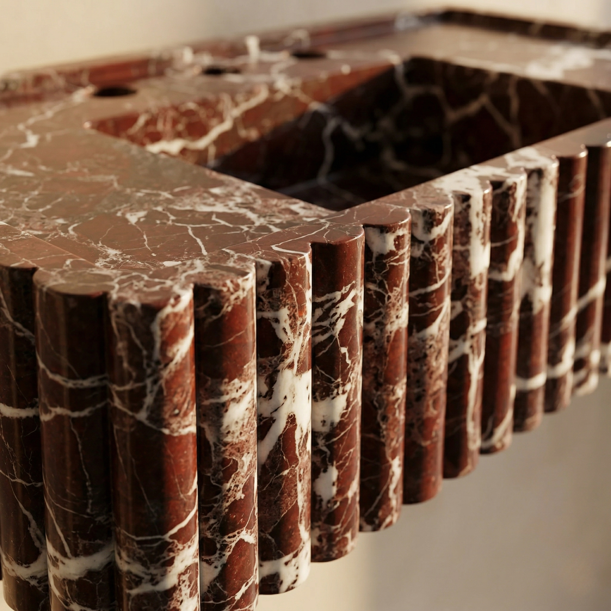 close up Rosso Levanto marble sink fluted texture natural veining detail