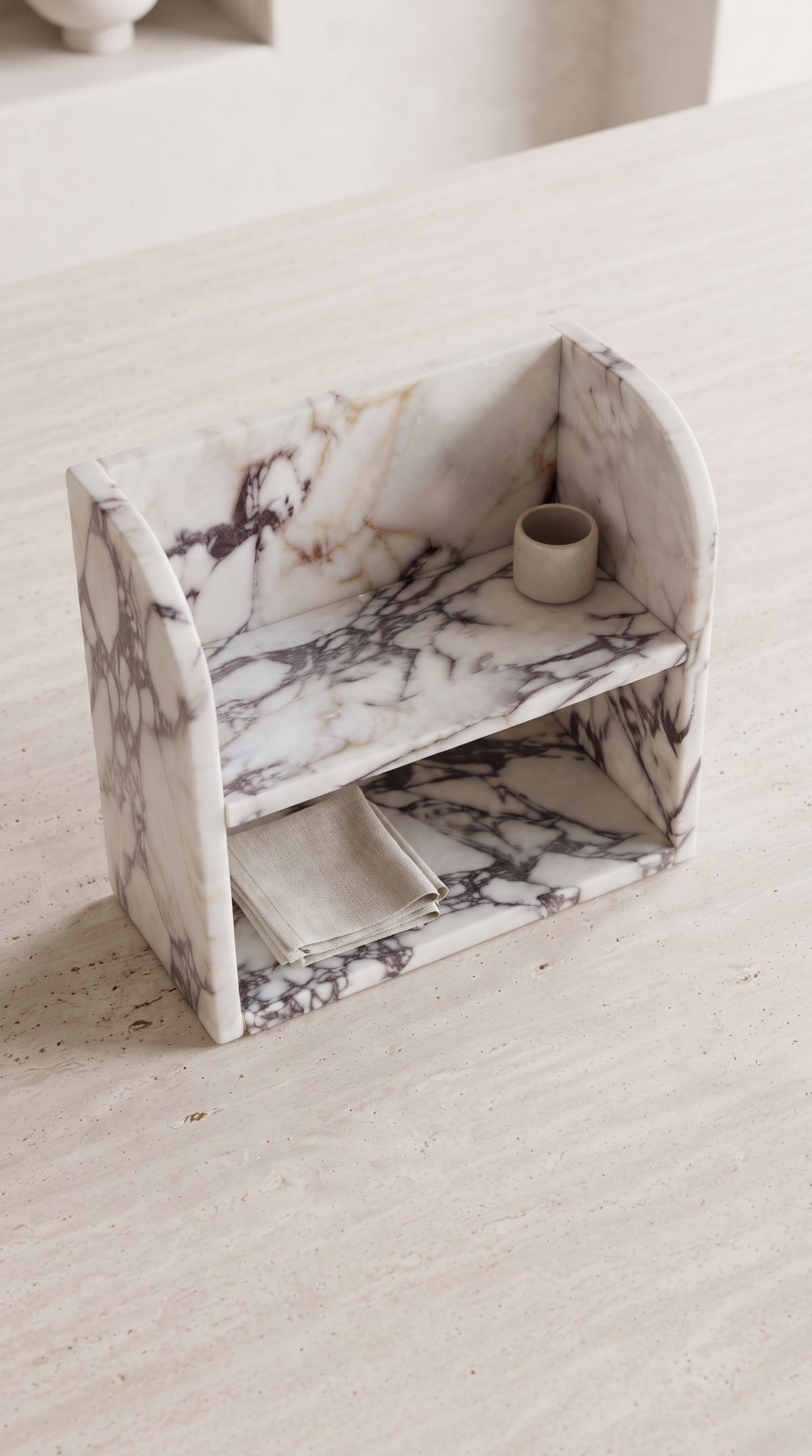 High-angle view of Calacatta Viola marble organizer showing two functional storage levels and compact depth
