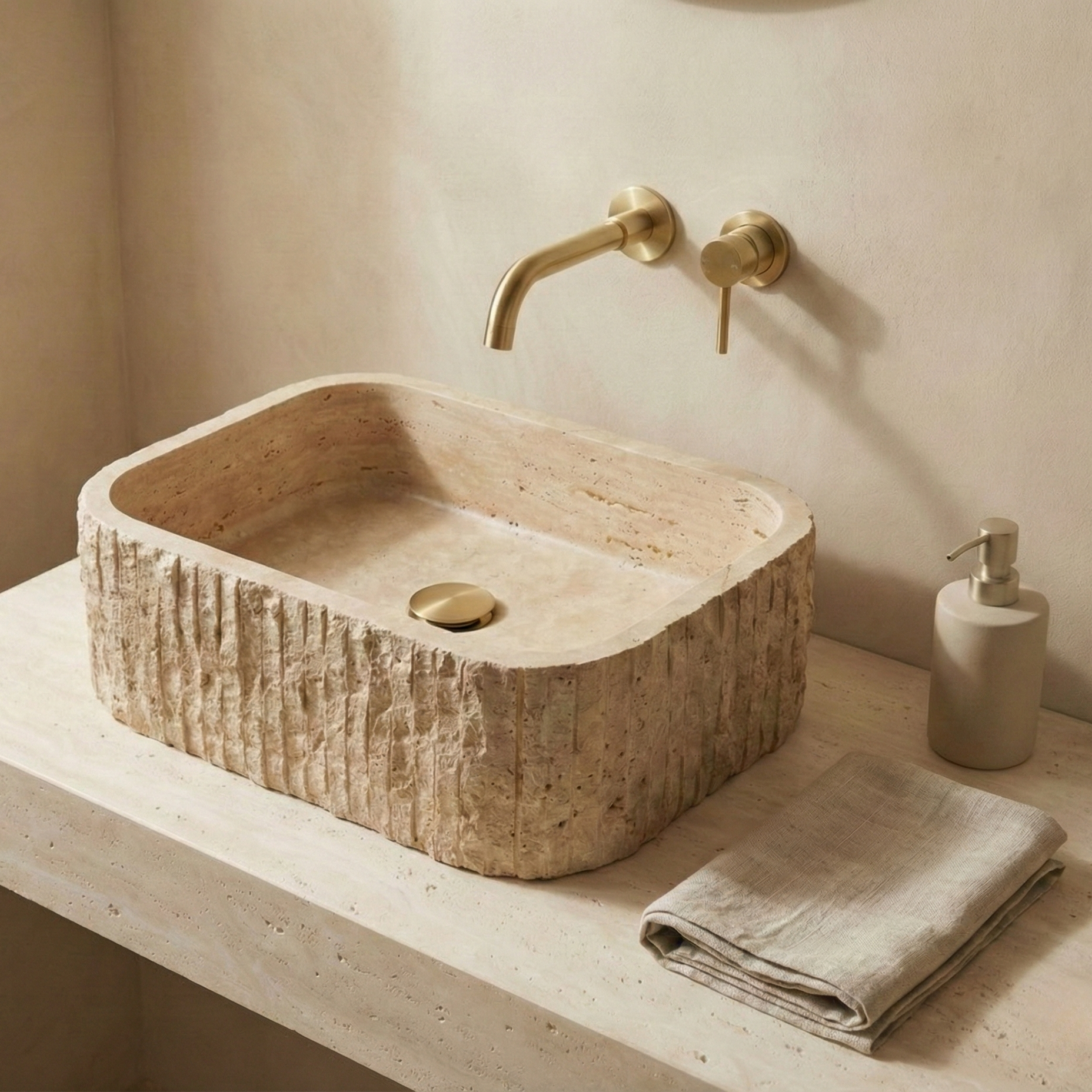 Travertine rectangular vessel sink with fluted exterior on minimalist beige bathroom vanity